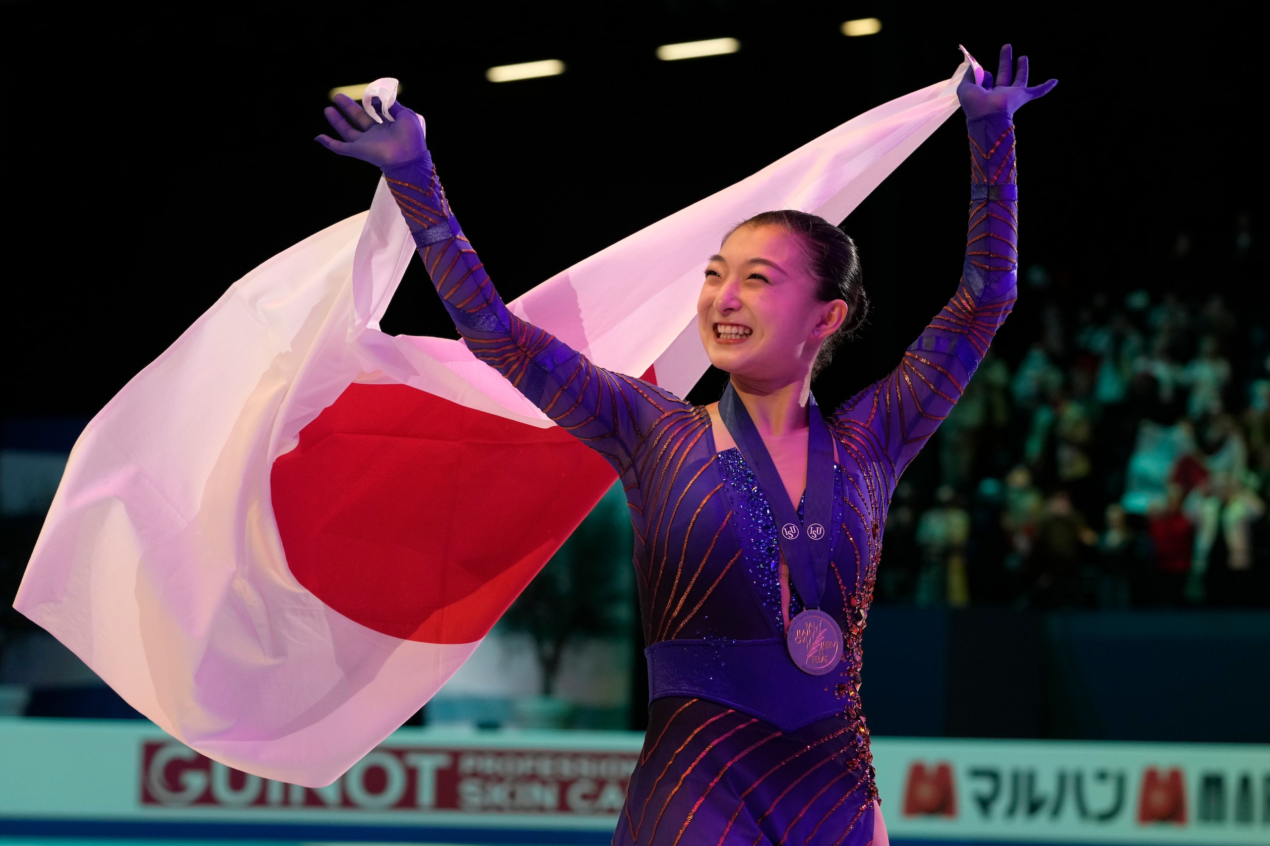 Kaori Sakamoto of Japan celebrates her gold medal during the women victory ceremony at the Figure Skating World Championships in Montpellier, south of France, Friday, March 25, 2022. (AP Photo/Francisco Seco)