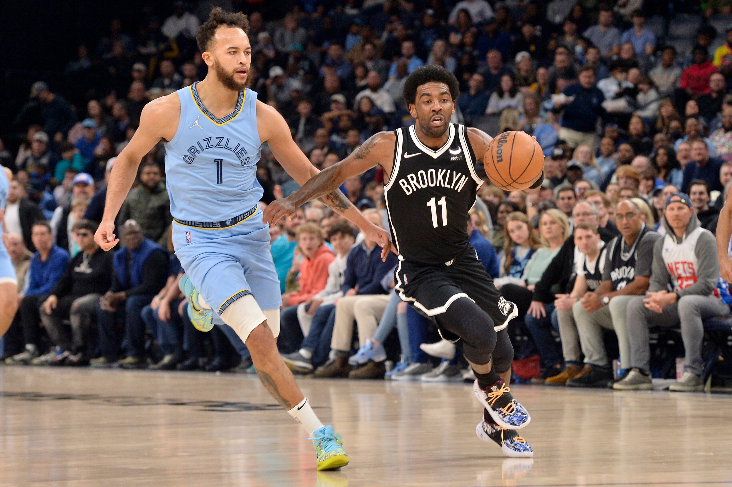 Brooklyn Nets guard Kyrie Irving (11) drives ahead of Memphis Grizzlies forward Kyle Anderson (1) in the first half of an NBA basketball game Wednesday, March 23, 2022, in Memphis, Tenn. (AP Photo/Brandon Dill)