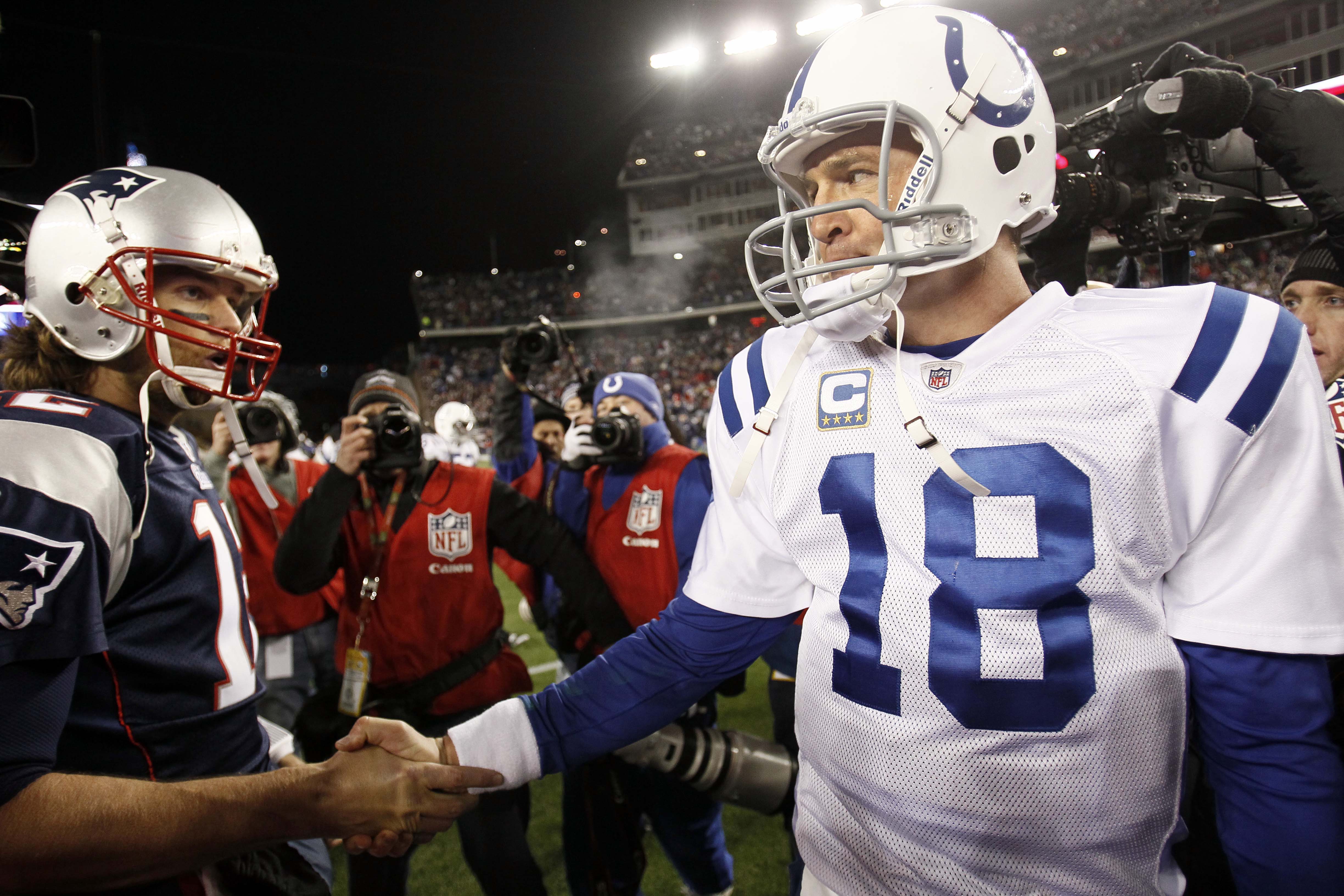 FILE - In this Nov. 21, 2010, file photo, Indianapolis Colts quarterback Peyton Manning (18) shakes hands with New England Patriots quarterback Tom Brady after New England's 31-28 win in an NFL football game in Foxborough, Mass. U.S. District Judge Susan Richard Nelson ordered an immediate end to the NFL's lockout Monday, April 25, 2011, siding with the players in their fight with the owners over how to divide the $9 billion business. Nelson granted a request for a preliminary injunction to lift the two-month lockout, saying she was swayed by the players' argument that the NFL's first work stoppage since 1987 is hurting their careers. Manning and Brady were among the players who filed the request for an injunction. (AP Photo/Winslow Townson, File)