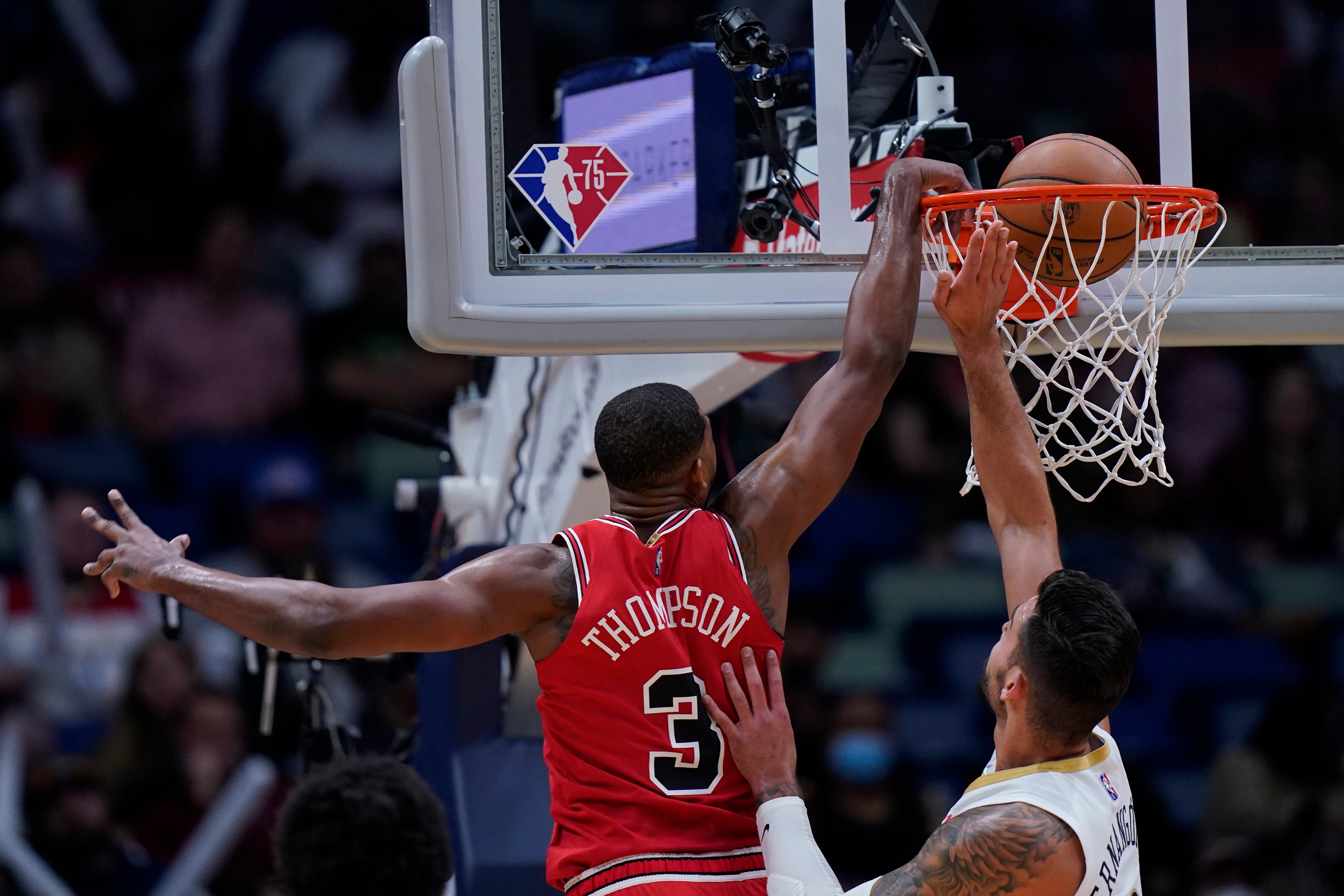 Chicago Bulls center Tristan Thompson (3) slam dunks over New Orleans Pelicans center Willy Hernangomez in the first half of an NBA basketball game in New Orleans, Thursday, March 24, 2022. (AP Photo/Gerald Herbert)
