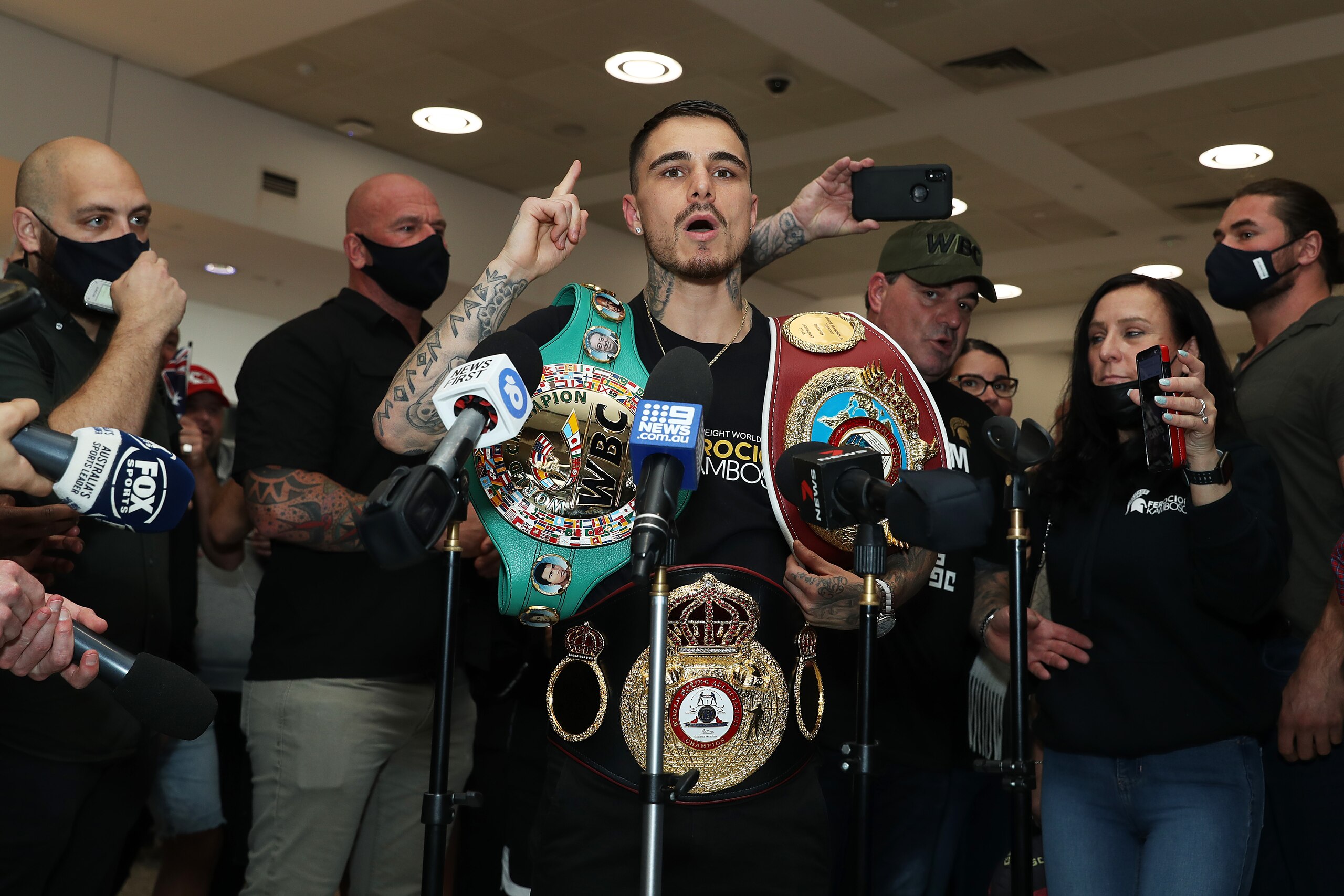 SYDNEY, AUSTRALIA - DECEMBER 09: Australian WBA, WBO & IBF Lightweight World Champion boxer George Kambosos poses at Sydney Airport on December 09, 2021 in Sydney, Australia. (Photo by Mark Metcalfe/Getty Images)