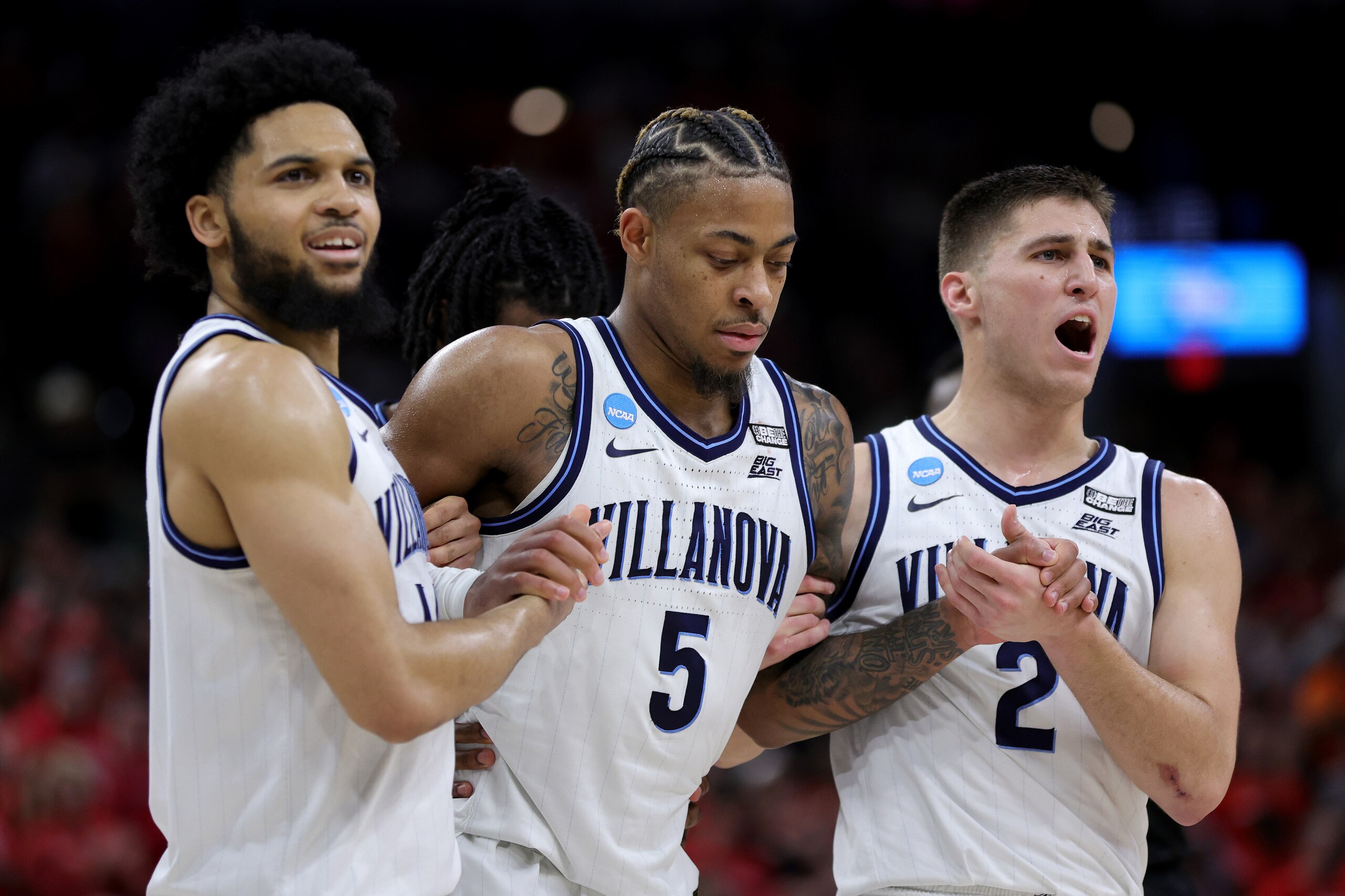 SAN ANTONIO, TEXAS - MARCH 26: Justin Moore #5 of the Villanova Wildcats is helped off the court after an injury during the second half of the game against the Houston Cougars in the NCAA Men's Basketball Tournament Elite 8 Round at AT&T Center on March 26, 2022 in San Antonio, Texas. (Photo by Carmen Mandato/Getty Images)