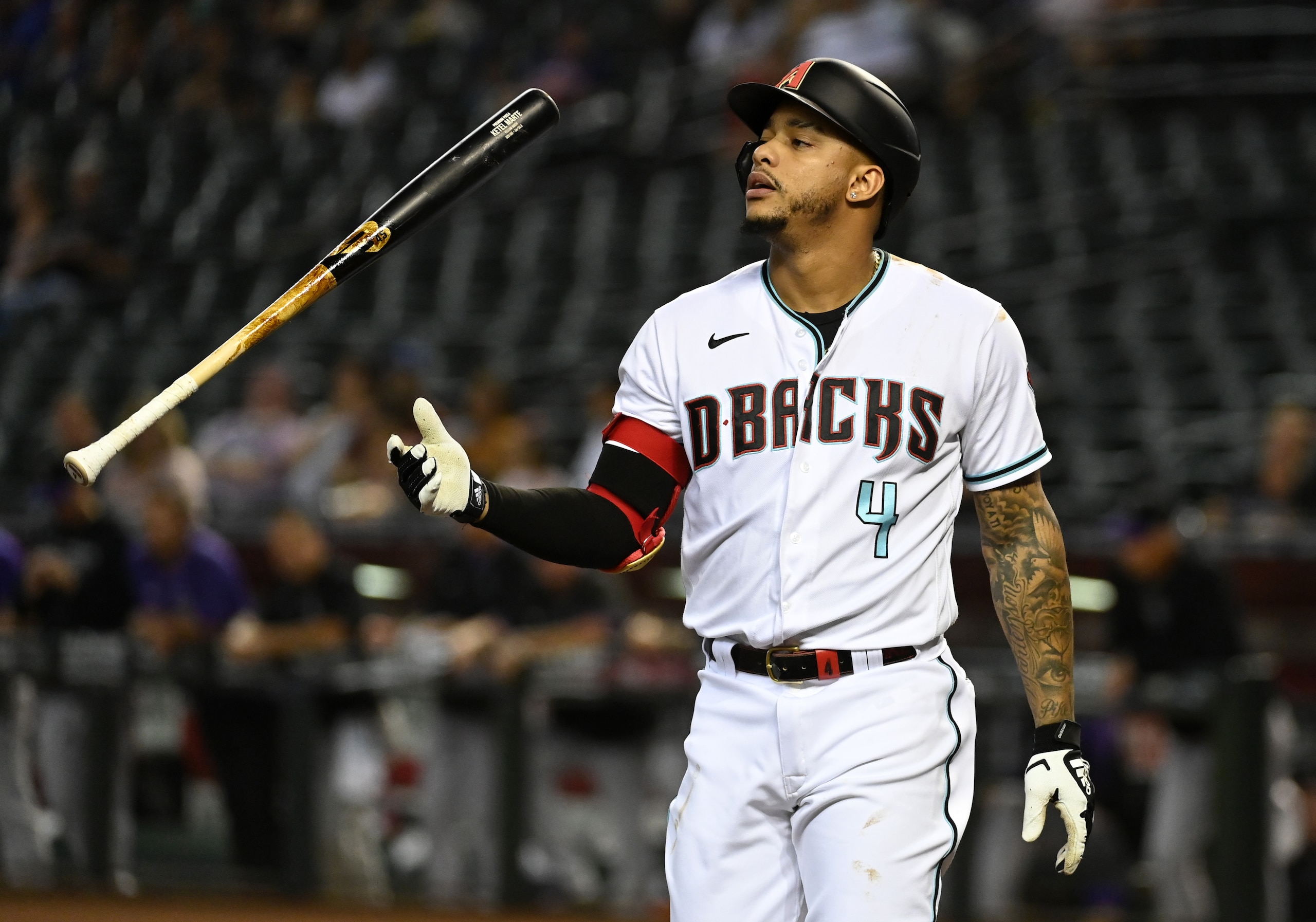 PHOENIX, ARIZONA - OCTOBER 01: Ketel Marte #4 of the Arizona Diamondbacks tosses his bat after being called out on strikes against the Colorado Rockies during the first inning at Chase Field on October 01, 2021 in Phoenix, Arizona. (Photo by Norm Hall/Getty Images)