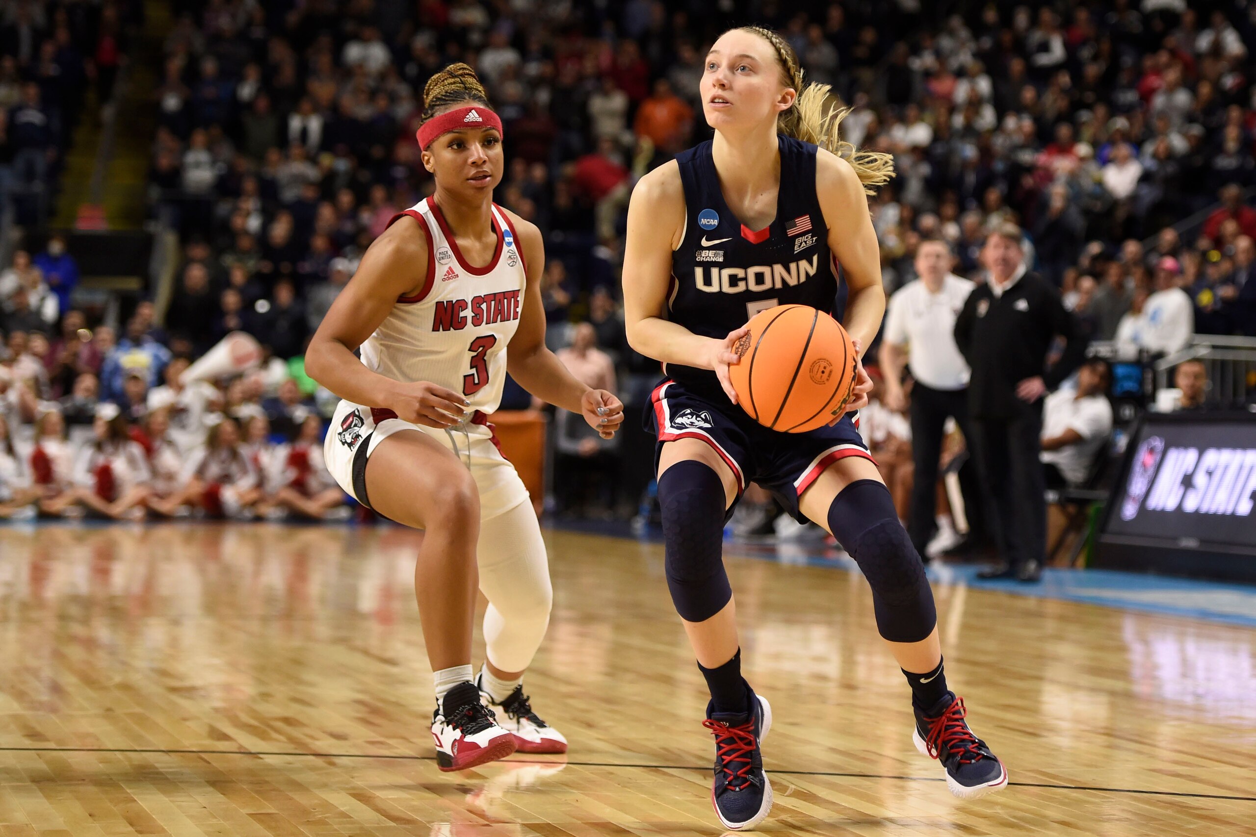 BRIDGEPORT, CT - MARCH 28: Paige Bueckers #5 of the Connecticut Huskies drives past Kai Crutchfield #3 of the N.C. State Wolfpack during the Elite Eight round of the 2022 NCAA Womens Basketball Tournament held at Total Mortgage Arena at Harbor Yard on March 28, 2022 in Bridgeport, Connecticut. (Photo by Khoi Ton/NCAA Photos via Getty Images) BRIDGEPORT, CT - MARCH 28: Paige Bueckers #5 of the Connecticut Huskies drives past Kai Crutchfield #3 of the N.C. State Wolfpack during the Elite Eight round of the 2022 NCAA Womens Basketball Tournament held at Total Mortgage Arena at Harbor Yard on March 28, 2022 in Bridgeport, Connecticut. (Photo by Khoi Ton/NCAA Photos via Getty Images)