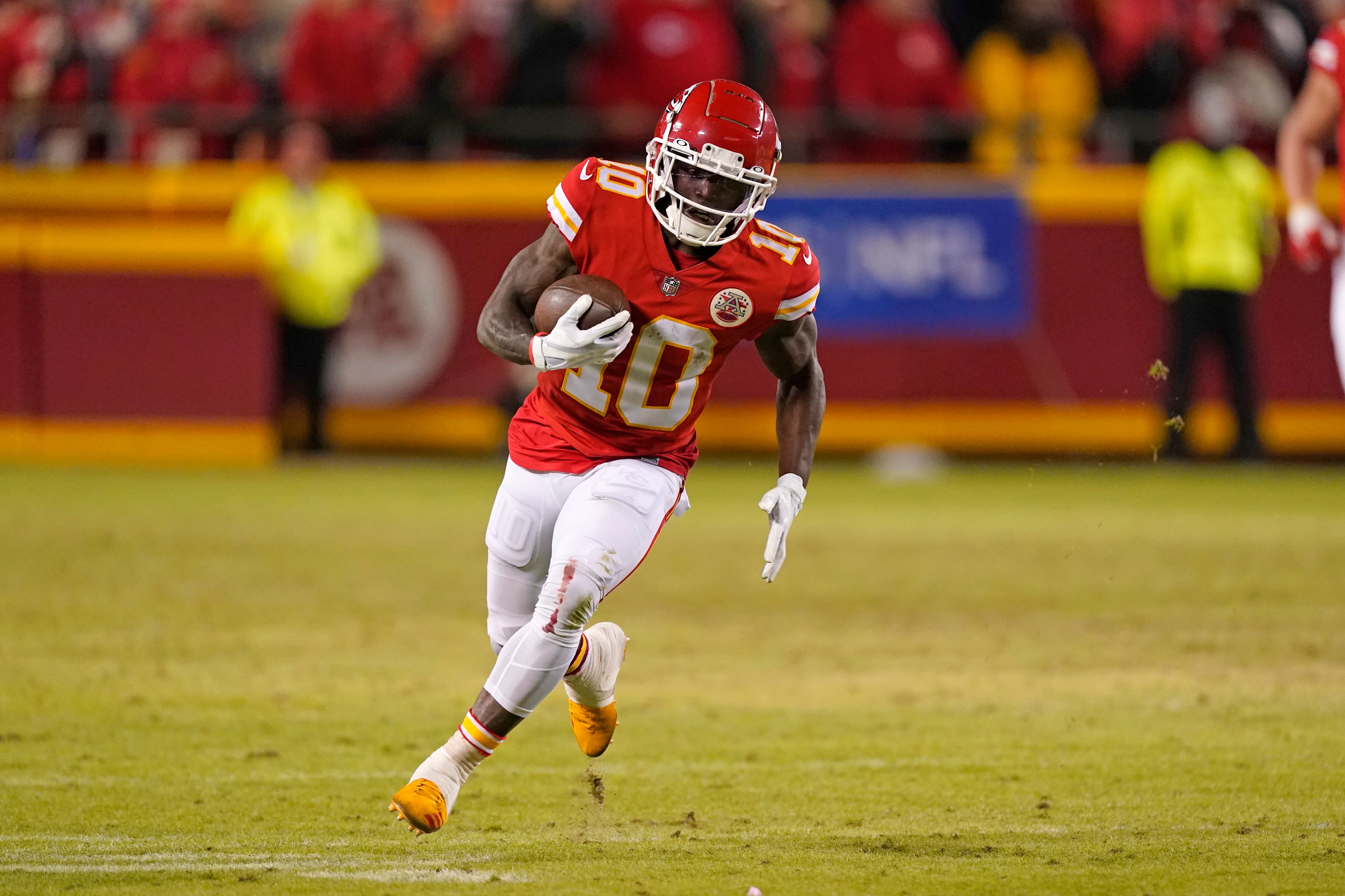 Kansas City Chiefs wide receiver Tyreek Hill runs the ball during the second half of an NFL divisional round playoff football game against the Buffalo Bills, Sunday, Jan. 23, 2022, in Kansas City, Mo. (AP Photo/Charlie Riedel)