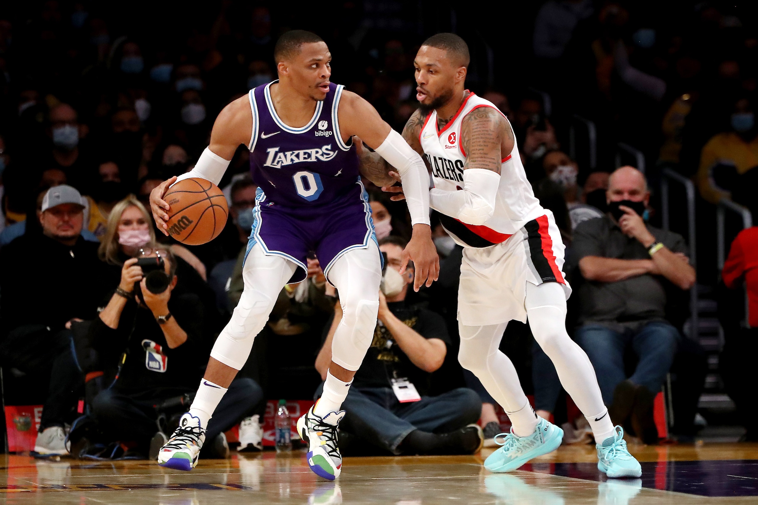 LOS ANGELES, CALIFORNIA - DECEMBER 31: Russell Westbrook #0 of the Los Angeles Lakers handles the ball against Damian Lillard #0 and Larry Nance Jr. #11 of the Portland Trail Blazers during the second quarter at Crypto.com Arena on December 31, 2021 in Los Angeles, California. NOTE TO USER: User expressly acknowledges and agrees that, by downloading and or using this photograph, User is consenting to the terms and conditions of the Getty Images License Agreement. (Photo by Katelyn Mulcahy/Getty Images)