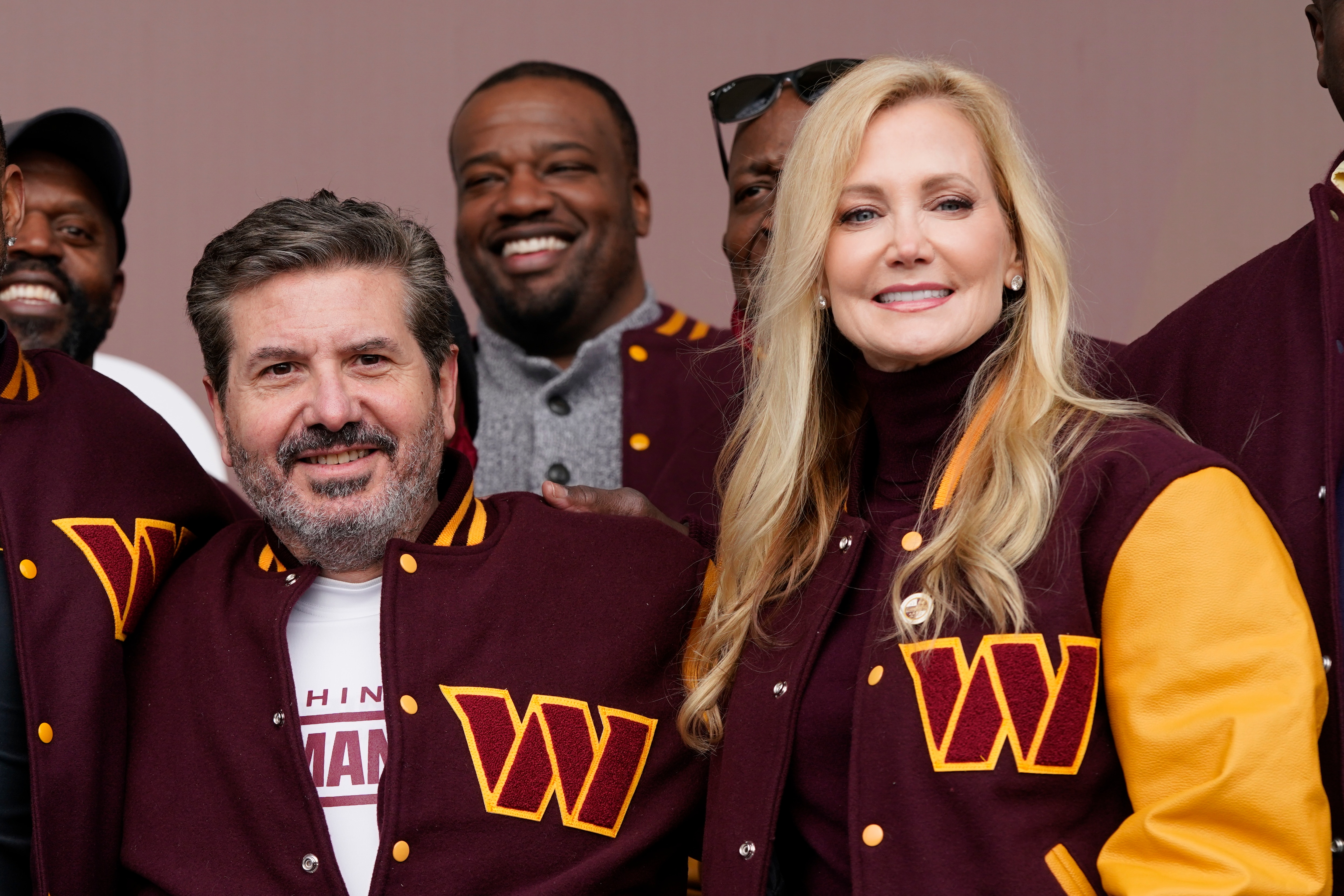 Dan and Tanya Snyder, co-owner and co-CEOs of the Washington Commanders, pose for photos after unveiling their NFL football team's new identity, Wednesday, Feb. 2, 2022, in Landover, Md. The new name comes 18 months after the once-storied franchise dropped its old moniker following decades of criticism that it was offensive to Native Americans. (AP Photo/Patrick Semansky)