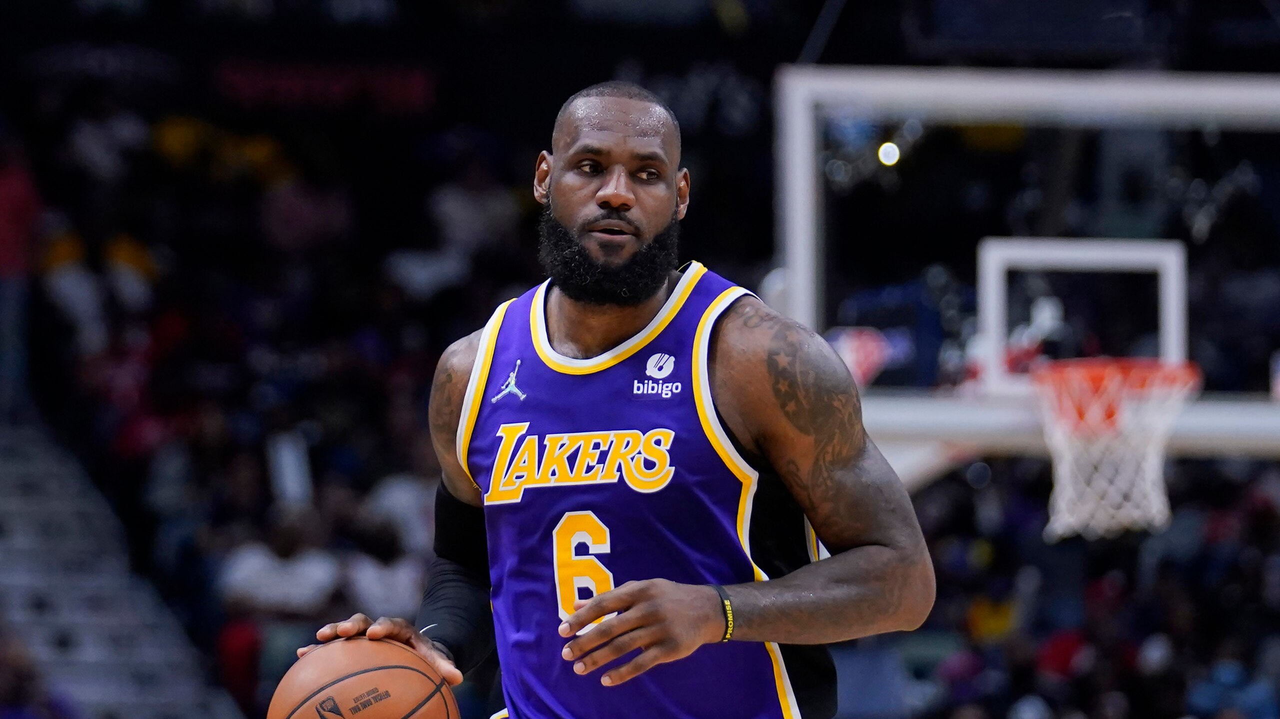 Los Angeles Lakers forward LeBron James (6) moves the ball down court in the first half of an NBA basketball game against the New Orleans Pelicans in New Orleans, Sunday, March 27, 2022. (AP Photo/Gerald Herbert)