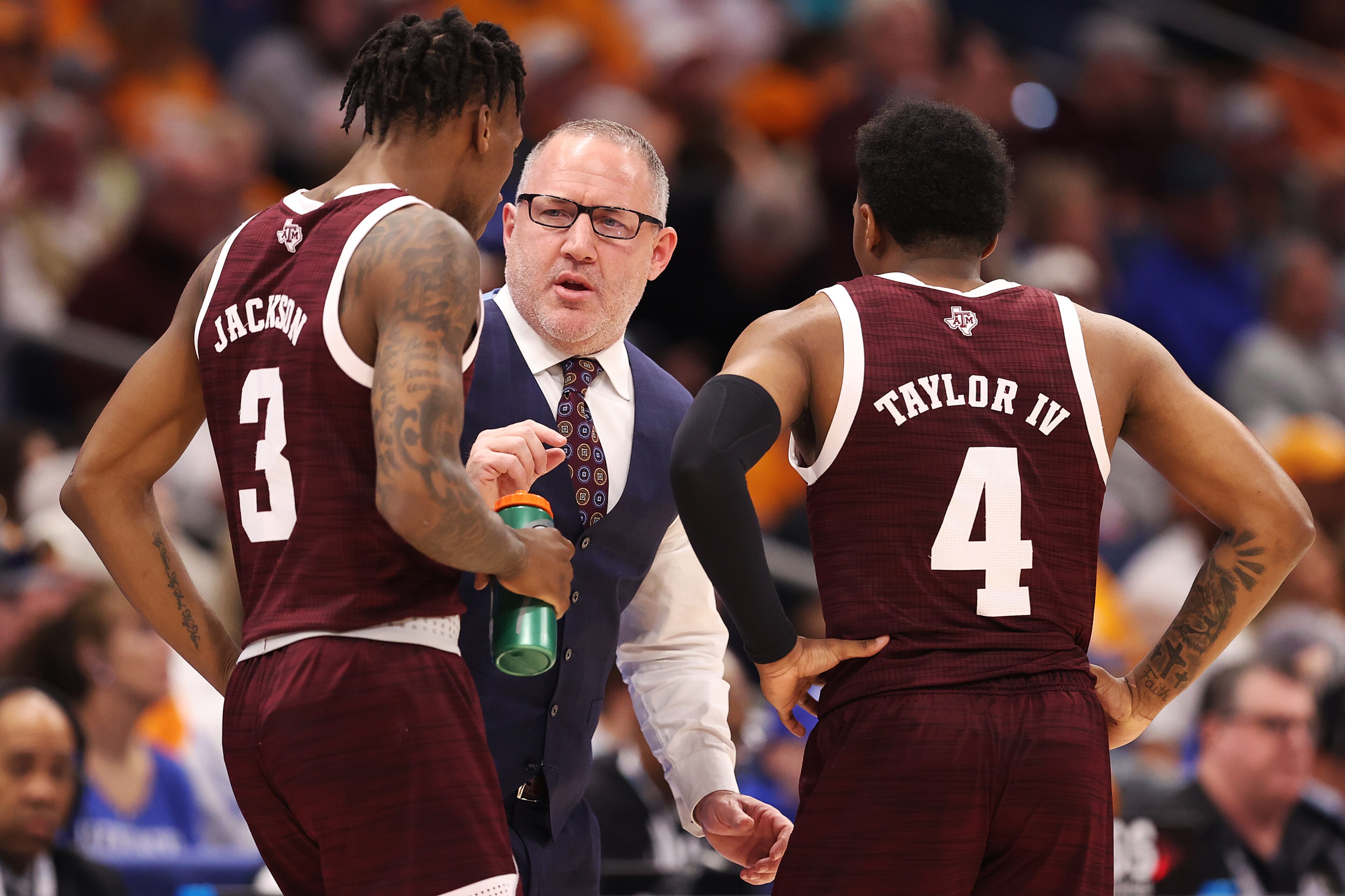 TAMPA, FLORIDA - MARCH 13: Head coach Buzz Williams of the Texas A&M Aggies talks with Quenton Jackson #3 and Wade Taylor IV #4 in the first half against the Tennessee Volunteers in the Championship game of the SEC Men's Tournament at Amalie Arena on March 13, 2022 in Tampa, Florida. (Photo by Andy Lyons/Getty Images) TAMPA, FLORIDA - MARCH 13: Head coach Buzz Williams of the Texas A&M Aggies talks with Quenton Jackson #3 and Wade Taylor IV #4 in the first half against the Tennessee Volunteers in the Championship game of the SEC Men's Tournament at Amalie Arena on March 13, 2022 in Tampa, Florida. (Photo by Andy Lyons/Getty Images)