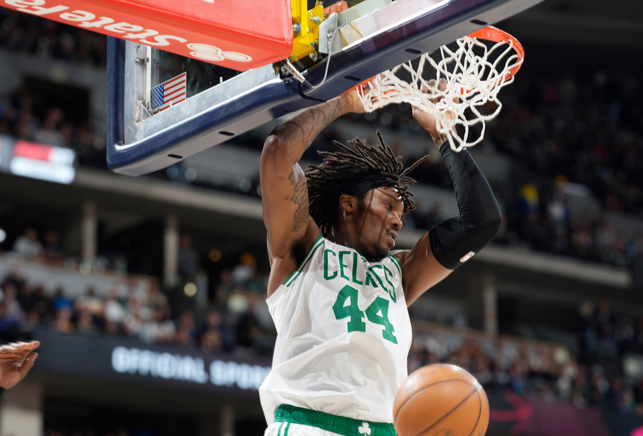 Boston Celtics center Robert Williams III hangs from the rim after dunking against the Denver Nuggets in the second half of an NBA basketball game Sunday, March 20, 2022, in Denver. (AP Photo/David Zalubowski) Boston Celtics center Robert Williams III hangs from the rim after dunking against the Denver Nuggets in the second half of an NBA basketball game Sunday, March 20, 2022, in Denver. (AP Photo/David Zalubowski)