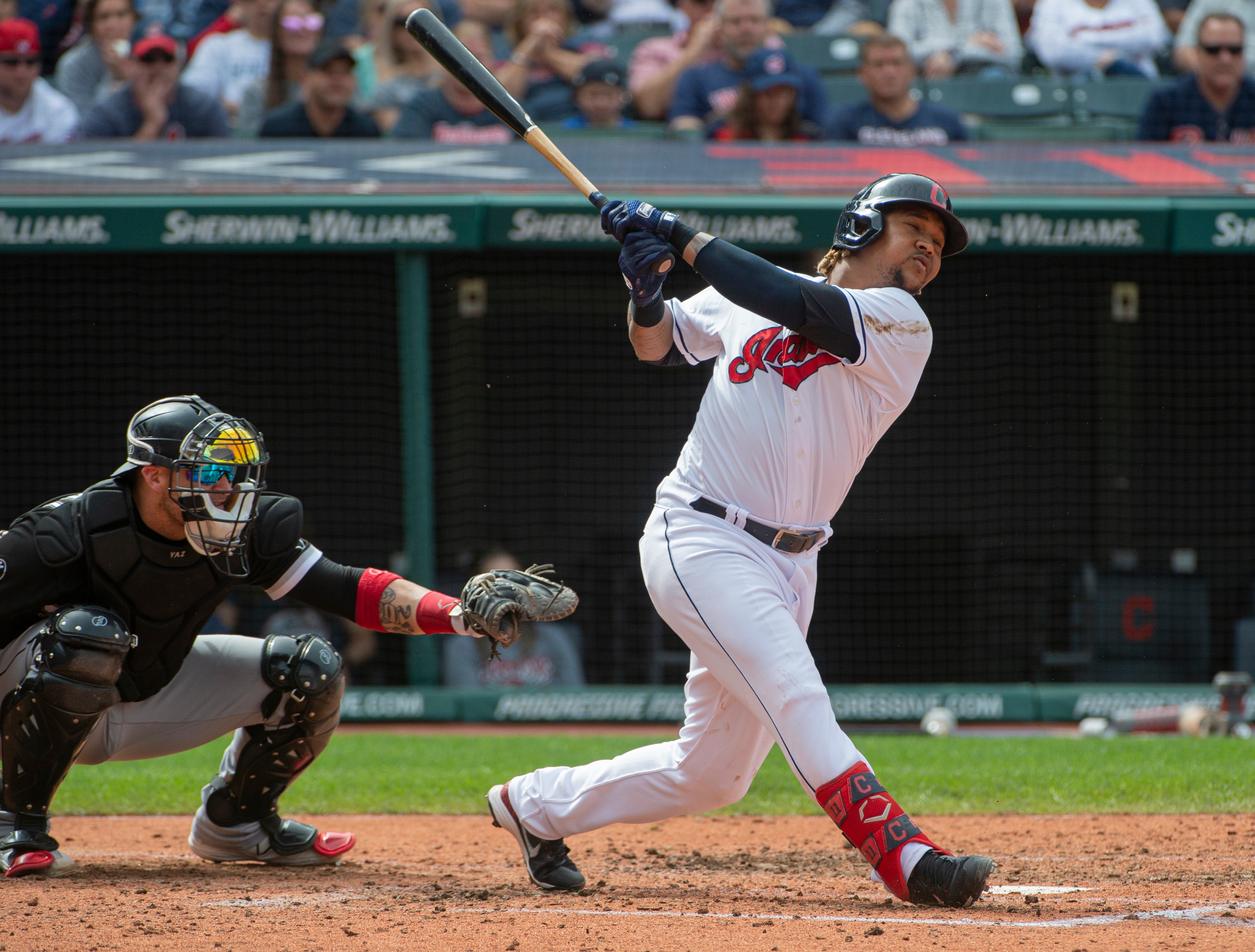Cleveland Indians' Jose Ramirez swings during a baseball game against the Chicago White Sox in Cleveland, Sunday, Sept. 26, 2021. Catching is Yasmani Grandal (AP Photo/Phil Long)
