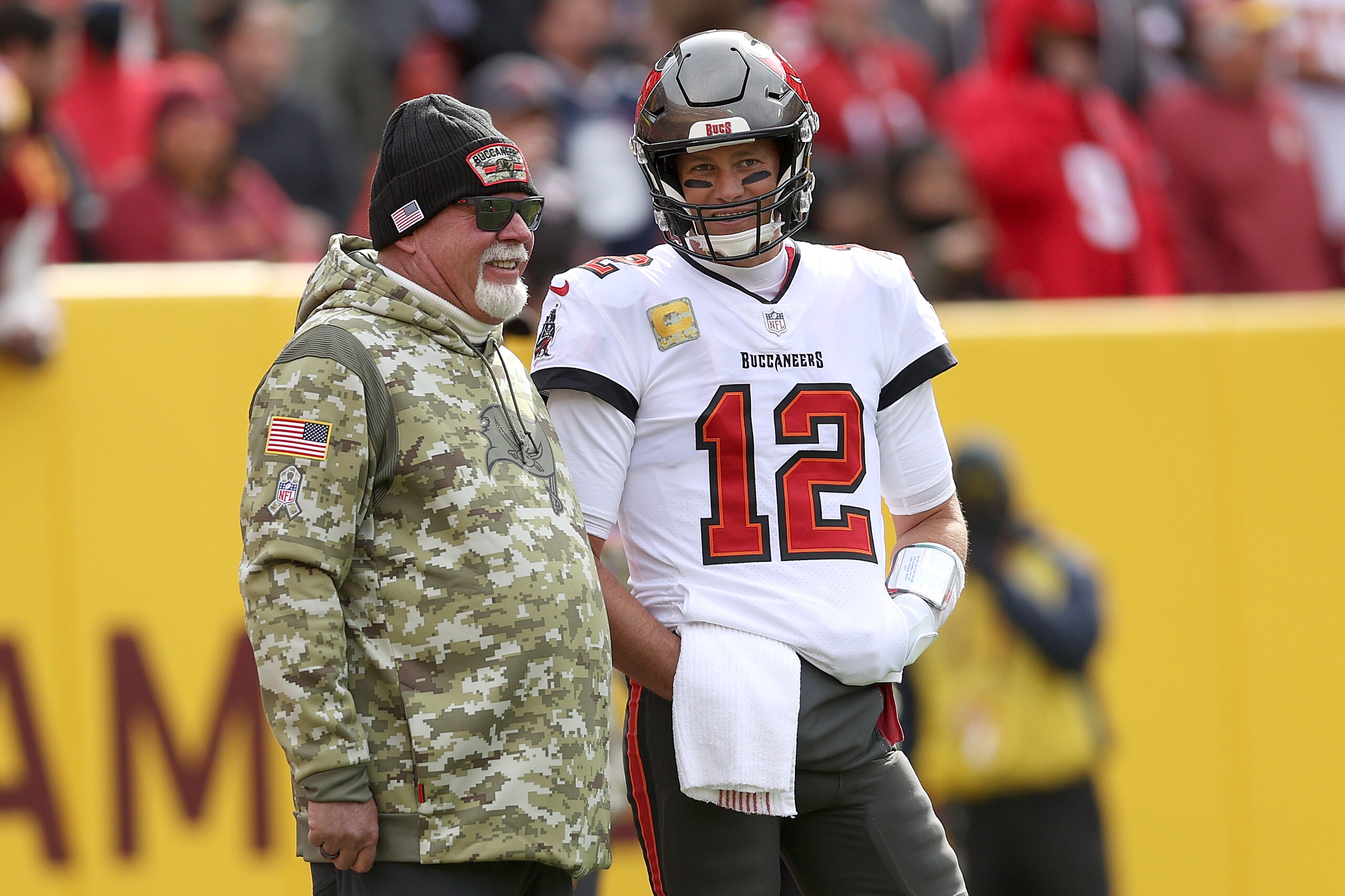 LANDOVER, MARYLAND - NOVEMBER 14: Head coach Bruce Arians of the Tampa Bay Buccaneers talks with quarterback Tom Brady #12 against the Washington Football Team at FedExField on November 14, 2021 in Landover, Maryland. (Photo by Rob Carr/Getty Images)