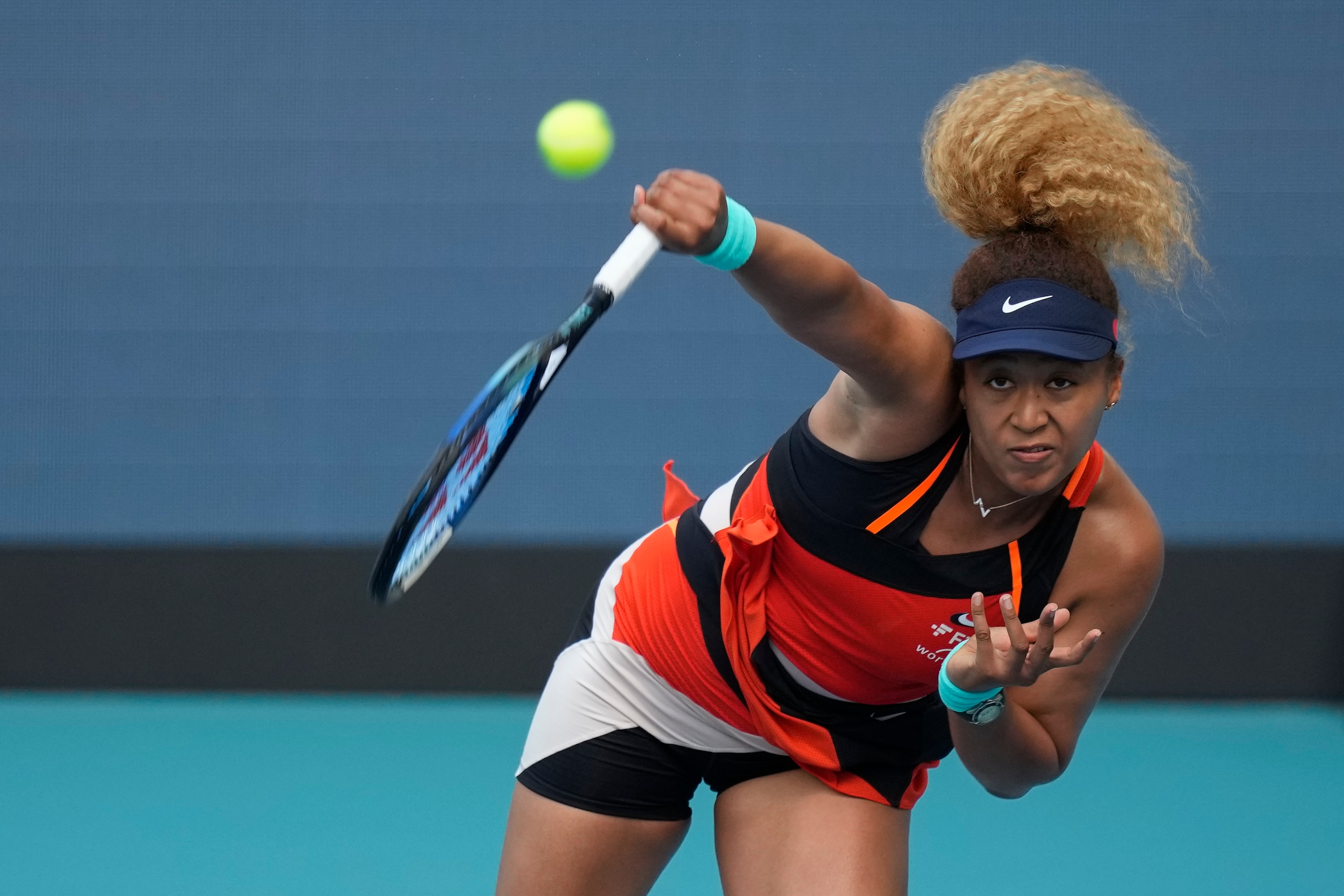 Naomi Osaka of Japan serves in her women's semifinal match against Belinda Bencic of Switzerland, at the Miami Open tennis tournament, Thursday, March 31, 2022, in Miami Gardens, Fla. (AP Photo/Rebecca Blackwell)