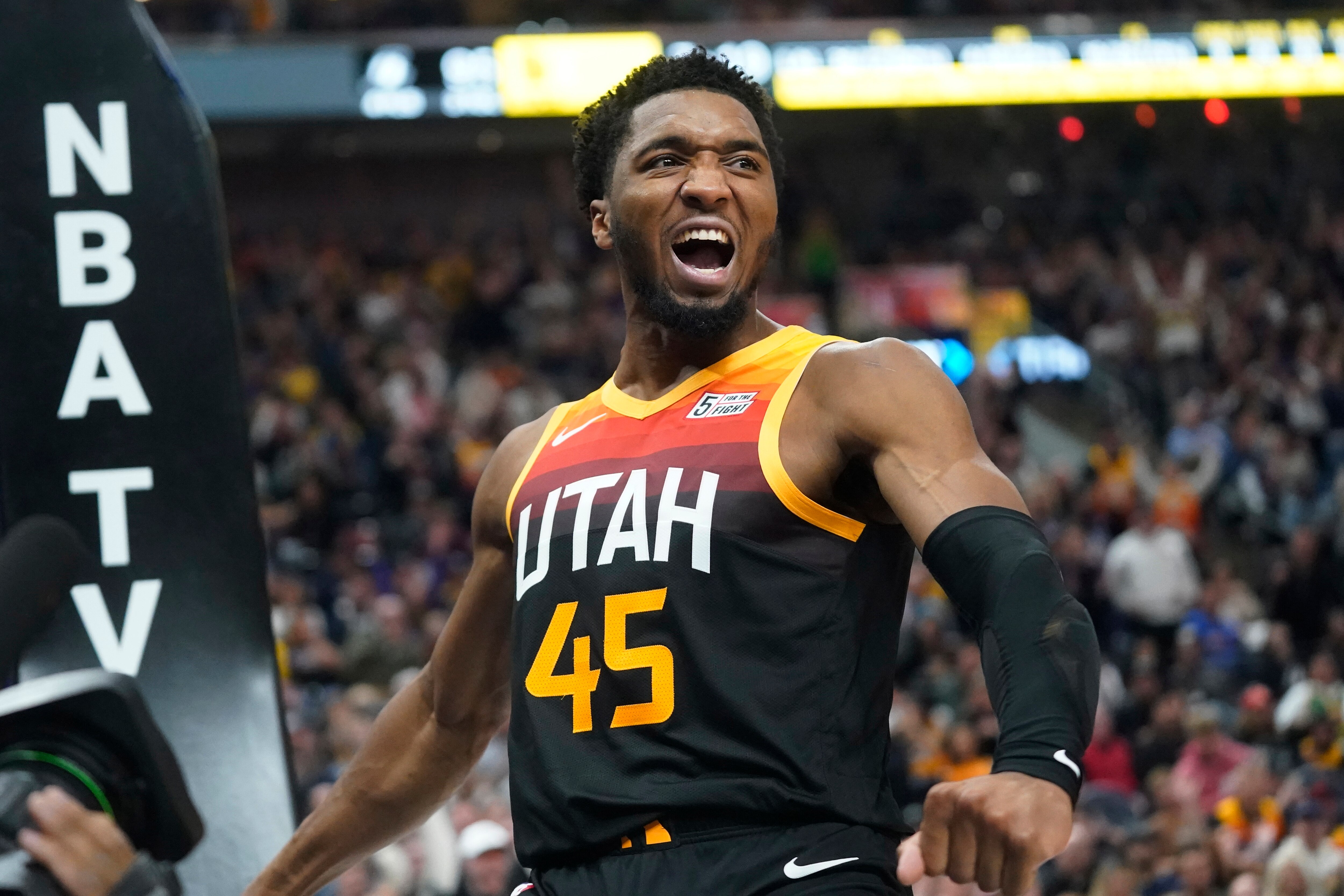 Utah Jazz guard Donovan Mitchell reacts after dunking against the Los Angeles Lakers during the second half of an NBA basketball game Thursday, March 31, 2022, in Salt Lake City. (AP Photo/Rick Bowmer)