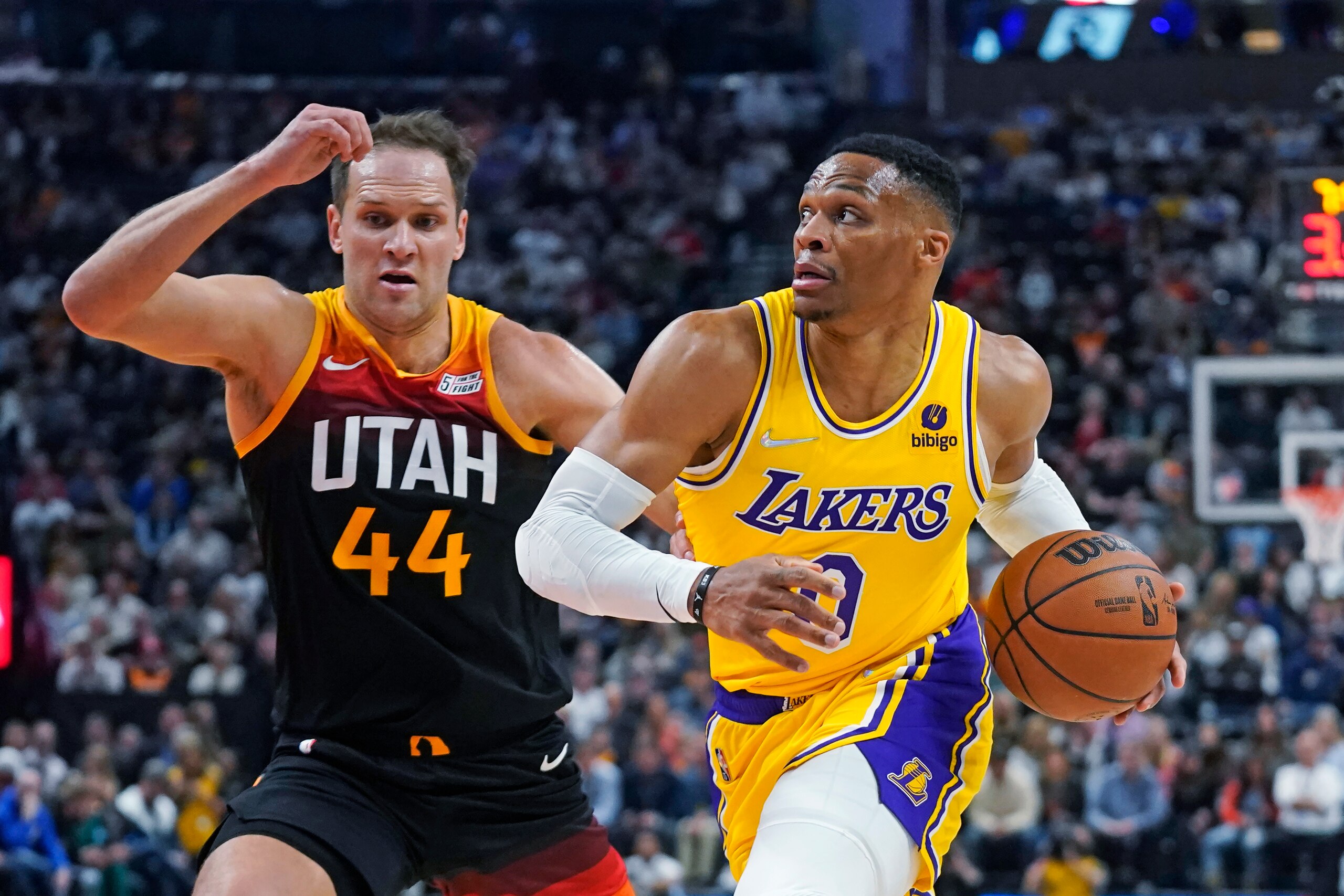 Los Angeles Lakers guard Russell Westbrook (0) drives to the basket as Utah Jazz forward Bojan Bogdanovic (44) defends during the first half of an NBA basketball game Thursday, March 31, 2022, in Salt Lake City. (AP Photo/Rick Bowmer)