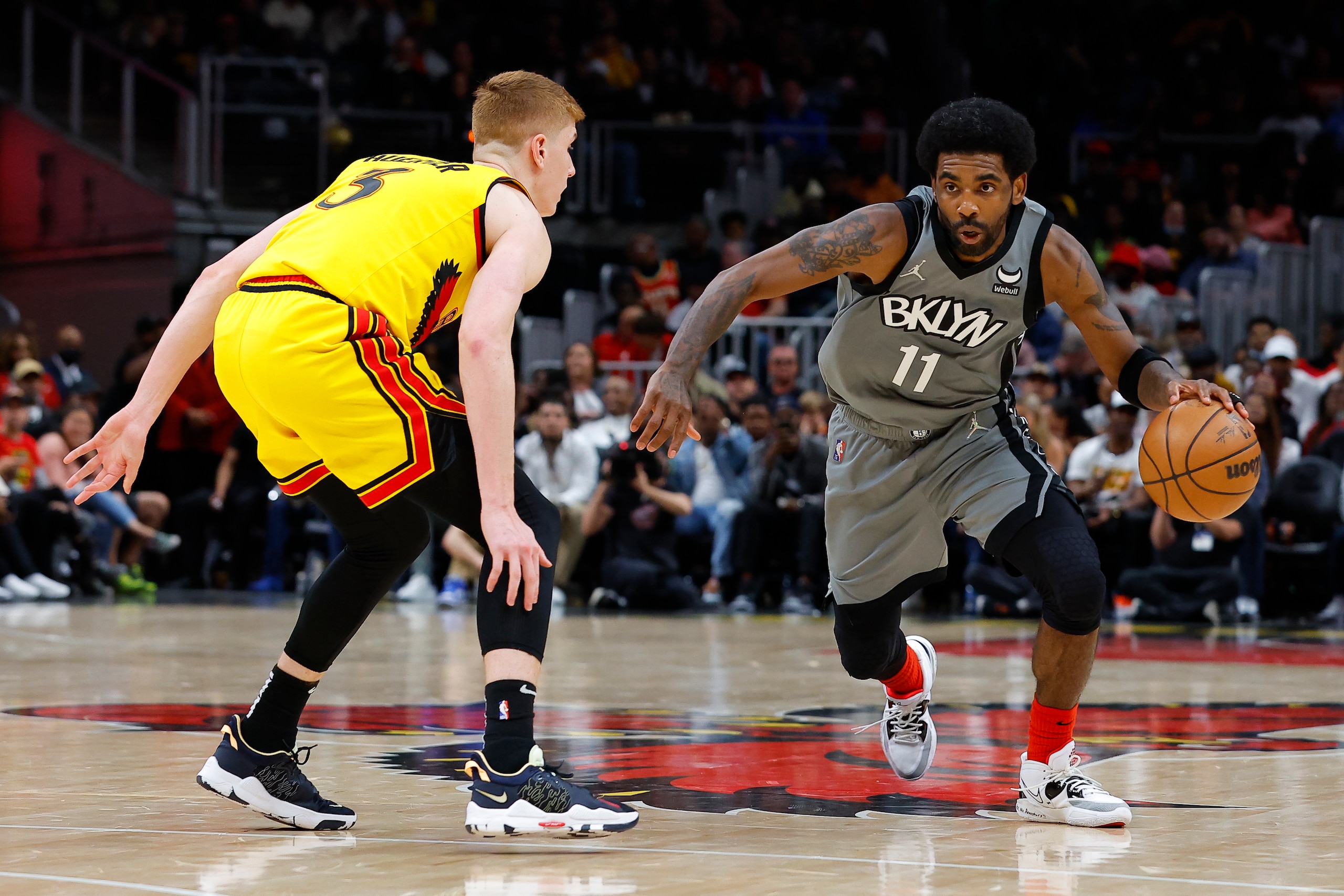 ATLANTA, GA - APRIL 02: Kyrie Irving #11 of the Brooklyn Nets drives to the basket against Kevin Huerter #3 of the Atlanta Hawks during the first half at State Farm Arena on April 2, 2022 in Atlanta, Georgia. NOTE TO USER: User expressly acknowledges and agrees that, by downloading and or using this photograph, User is consenting to the terms and conditions of the Getty Images License Agreement. (Photo by Todd Kirkland/Getty Images) ATLANTA, GA - APRIL 02: Kyrie Irving #11 of the Brooklyn Nets drives to the basket against Kevin Huerter #3 of the Atlanta Hawks during the first half at State Farm Arena on April 2, 2022 in Atlanta, Georgia. NOTE TO USER: User expressly acknowledges and agrees that, by downloading and or using this photograph, User is consenting to the terms and conditions of the Getty Images License Agreement. (Photo by Todd Kirkland/Getty Images)