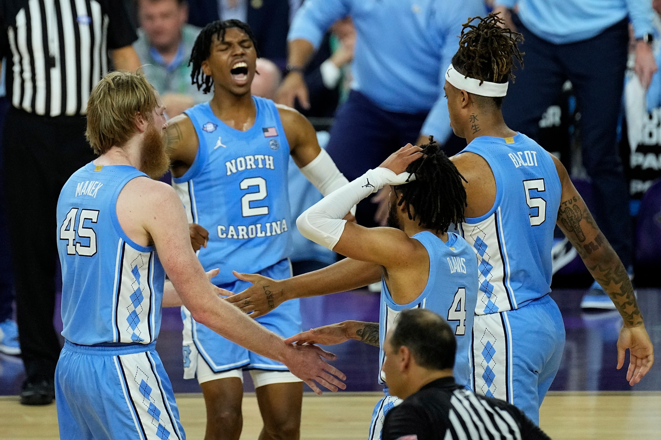 North Carolina celebrates during the second half of a college basketball game against Duke, in the semifinal round of the Men's Final Four NCAA tournament, Saturday, April 2, 2022, in New Orleans. (AP Photo/Gerald Herbert)