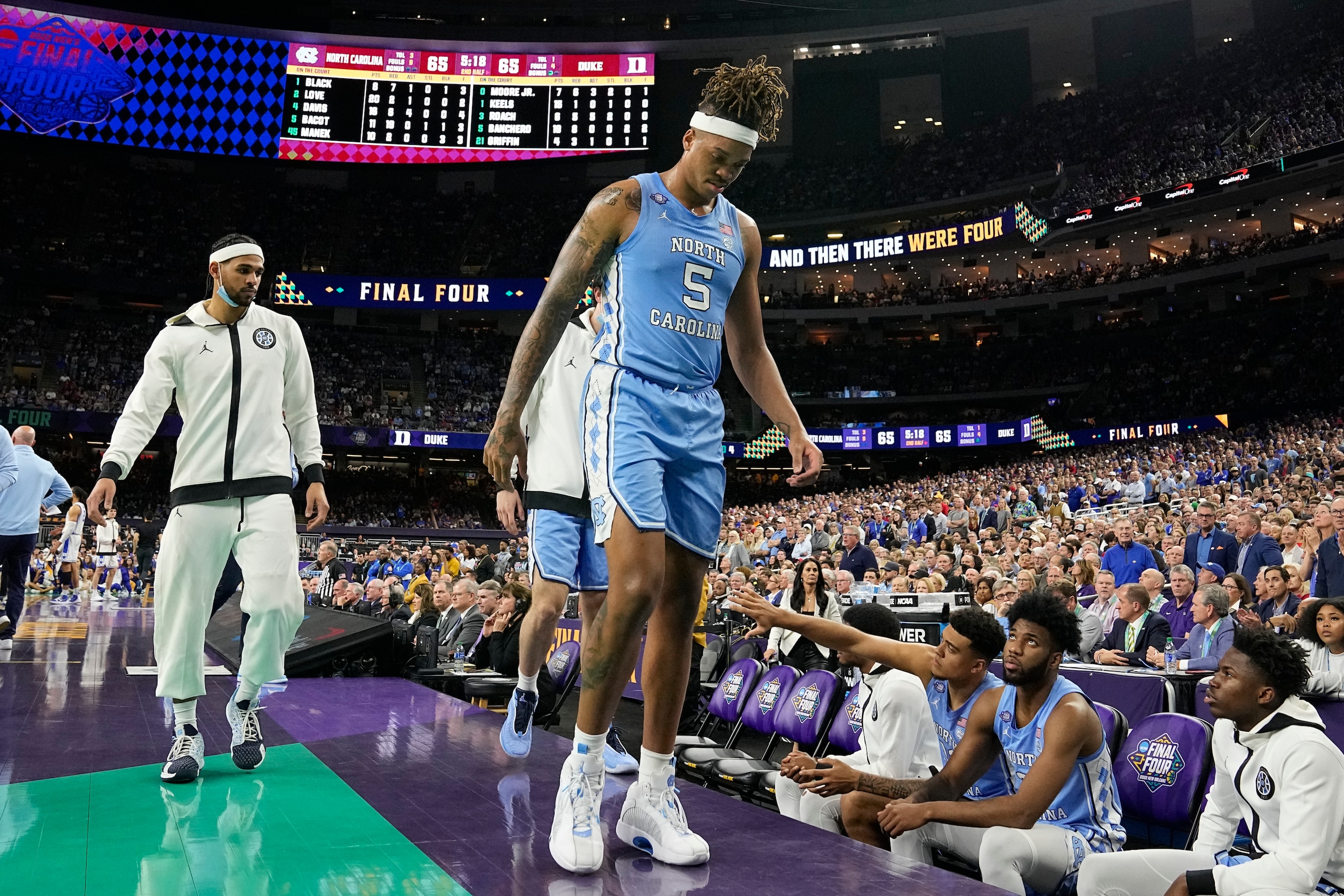 North Carolina forward Armando Bacot (5) leaves the court after being hurt during the second half of a college basketball game against Duke in the semifinal round of the Men's Final Four NCAA tournament, Saturday, April 2, 2022, in New Orleans. (AP Photo/Brynn Anderson)