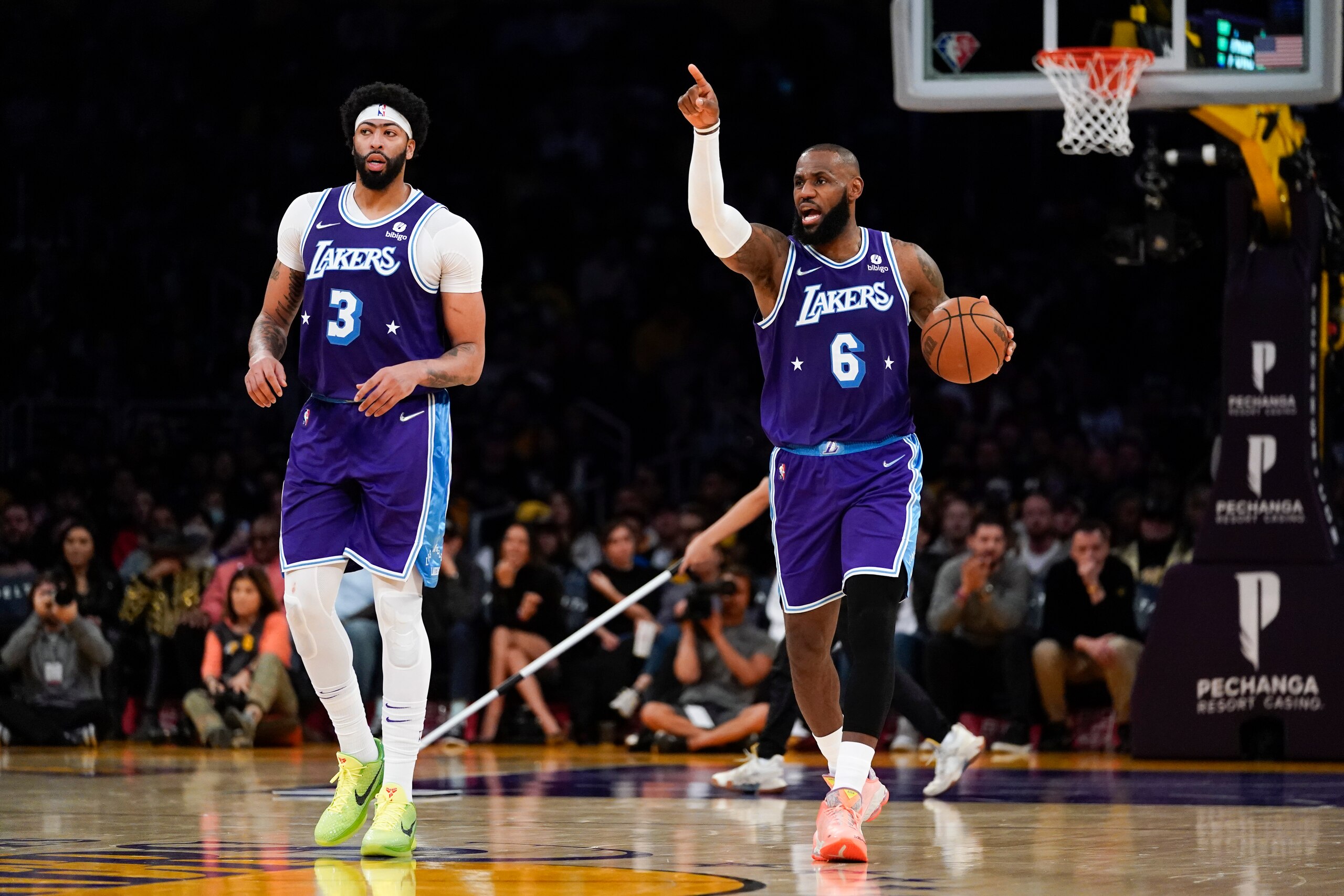 Los Angeles Lakers forward Anthony Davis (3) and forward LeBron James (6) walk down the court during the second half of an NBA basketball game against the New Orleans Pelicans in Los Angeles, Friday, April 1, 2022. (AP Photo/Ashley Landis)