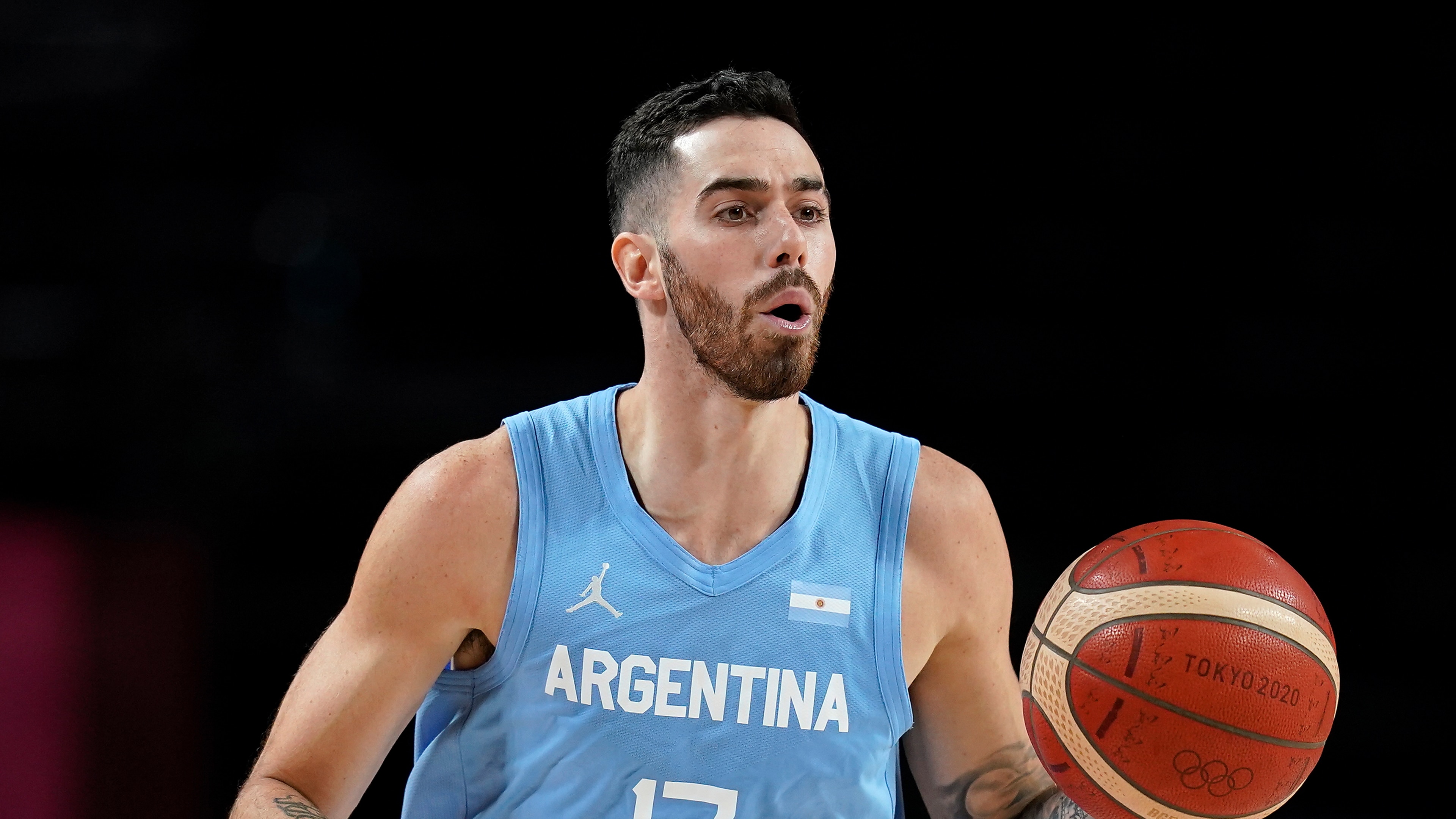 Argentina's Luca Vildoza (17) drives up court during a men's basketball quarterfinal round game against Australia at the 2020 Summer Olympics, Tuesday, Aug. 3, 2021, in Saitama, Japan. (AP Photo/Charlie Neibergall)