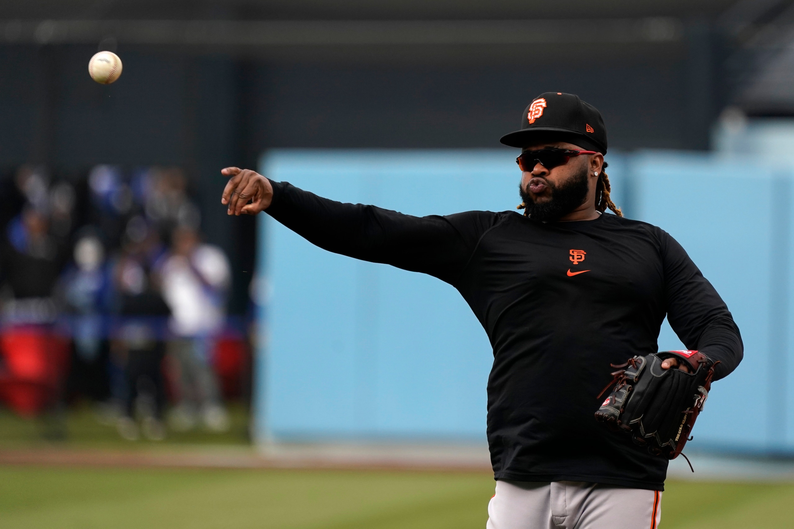 San Francisco Giants' Johnny Cueto throws during batting practice before Game 3 of a baseball National League Division Series against the Los Angeles Dodgers, Monday, Oct. 11, 2021, in Los Angeles. (AP Photo/Marcio Sanchez)