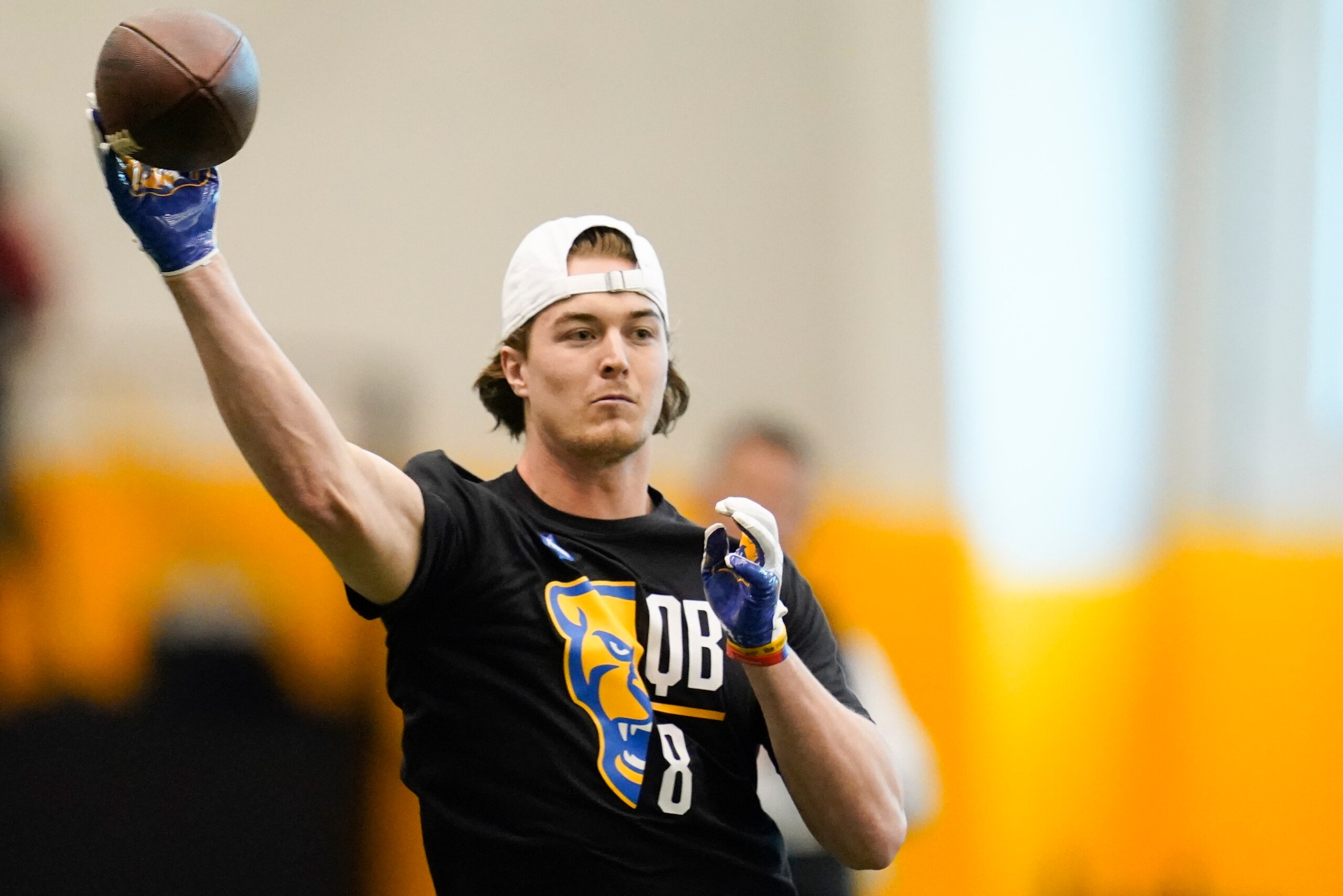 Quarterback Kenny Pickett (8) goes through passing drills during Pittsburgh's football pro day , Monday, March 21, 2022, in Pittsburgh. (AP Photo/Keith Srakocic)