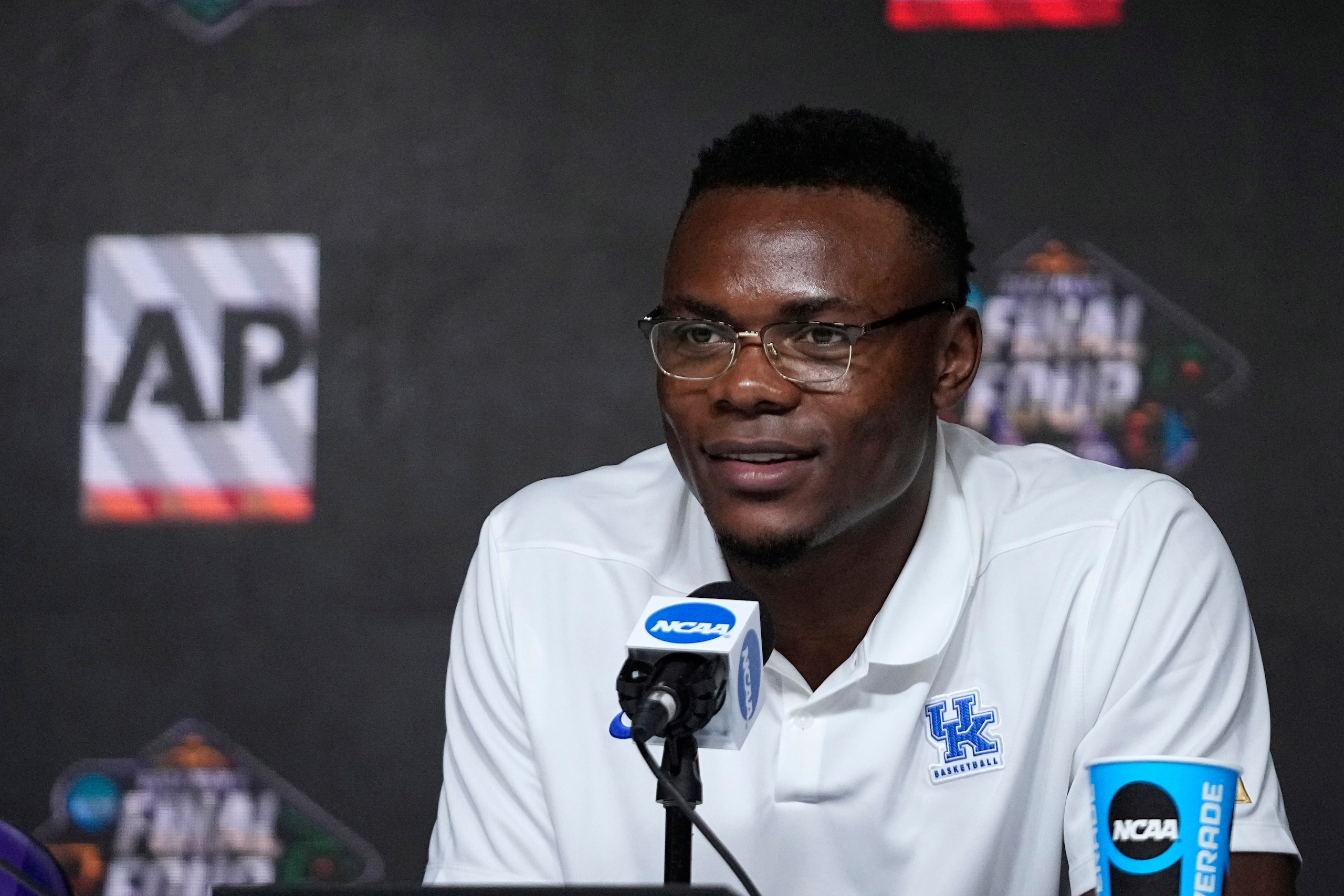 Oscar Tshiebwe of Kentucky speaks as he is introduced as The Associated Press men's basketball player of the year, in New Orleans, Friday, April 1, 2022. The 6-foot-9, 255-pound junior received 46 of 60 votes from a national media panel. Wisconsin's Johnny Davis was second with 10 votes. (AP Photo/Gerald Herbert) Oscar Tshiebwe of Kentucky speaks as he is introduced as The Associated Press men's basketball player of the year, in New Orleans, Friday, April 1, 2022. The 6-foot-9, 255-pound junior received 46 of 60 votes from a national media panel. Wisconsin's Johnny Davis was second with 10 votes. (AP Photo/Gerald Herbert)