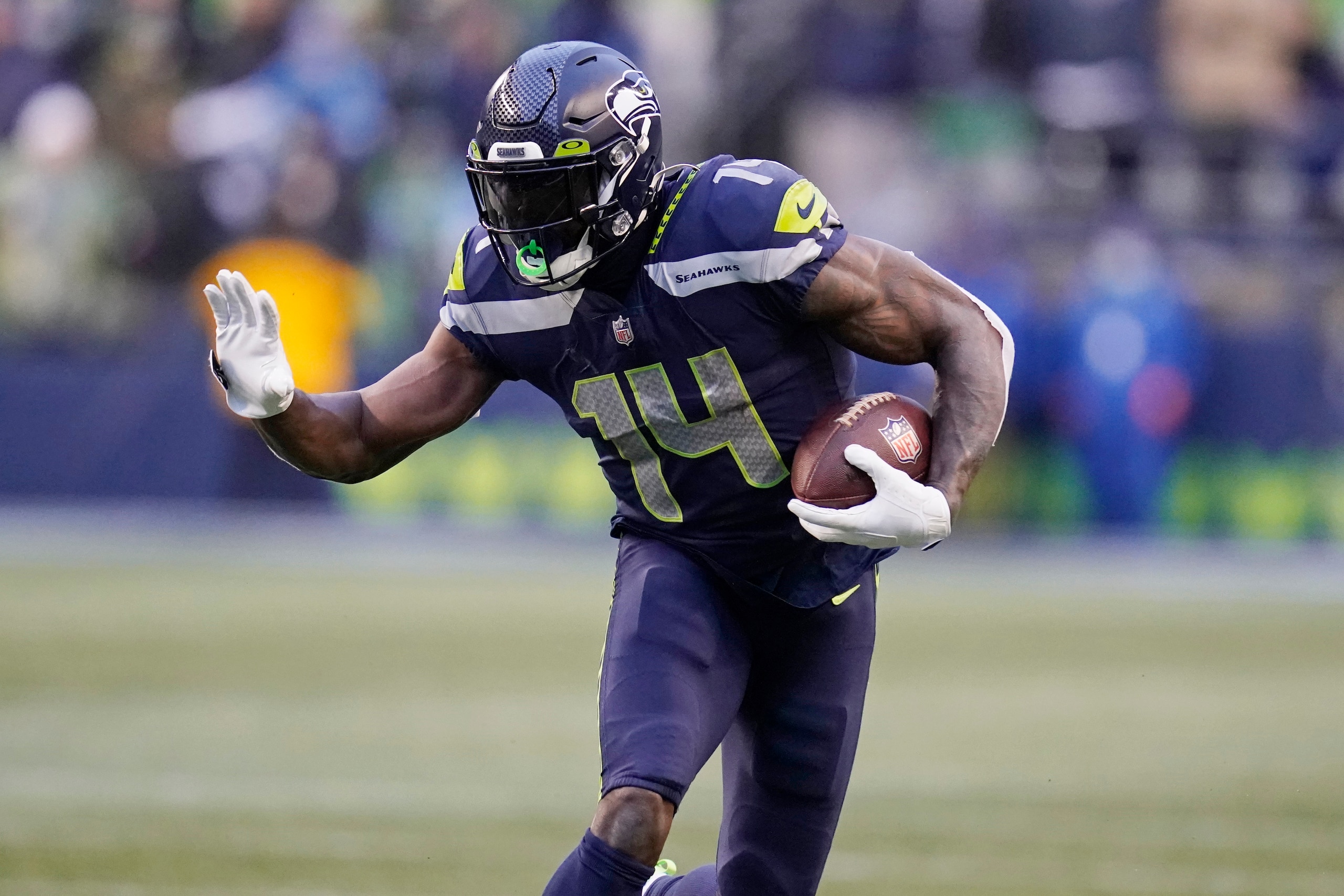 Seattle Seahawks wide receiver DK Metcalf carries the ball against the Detroit Lions during the second half of an NFL football game, Sunday, Jan. 2, 2022, in Seattle. (AP Photo/Elaine Thompson)