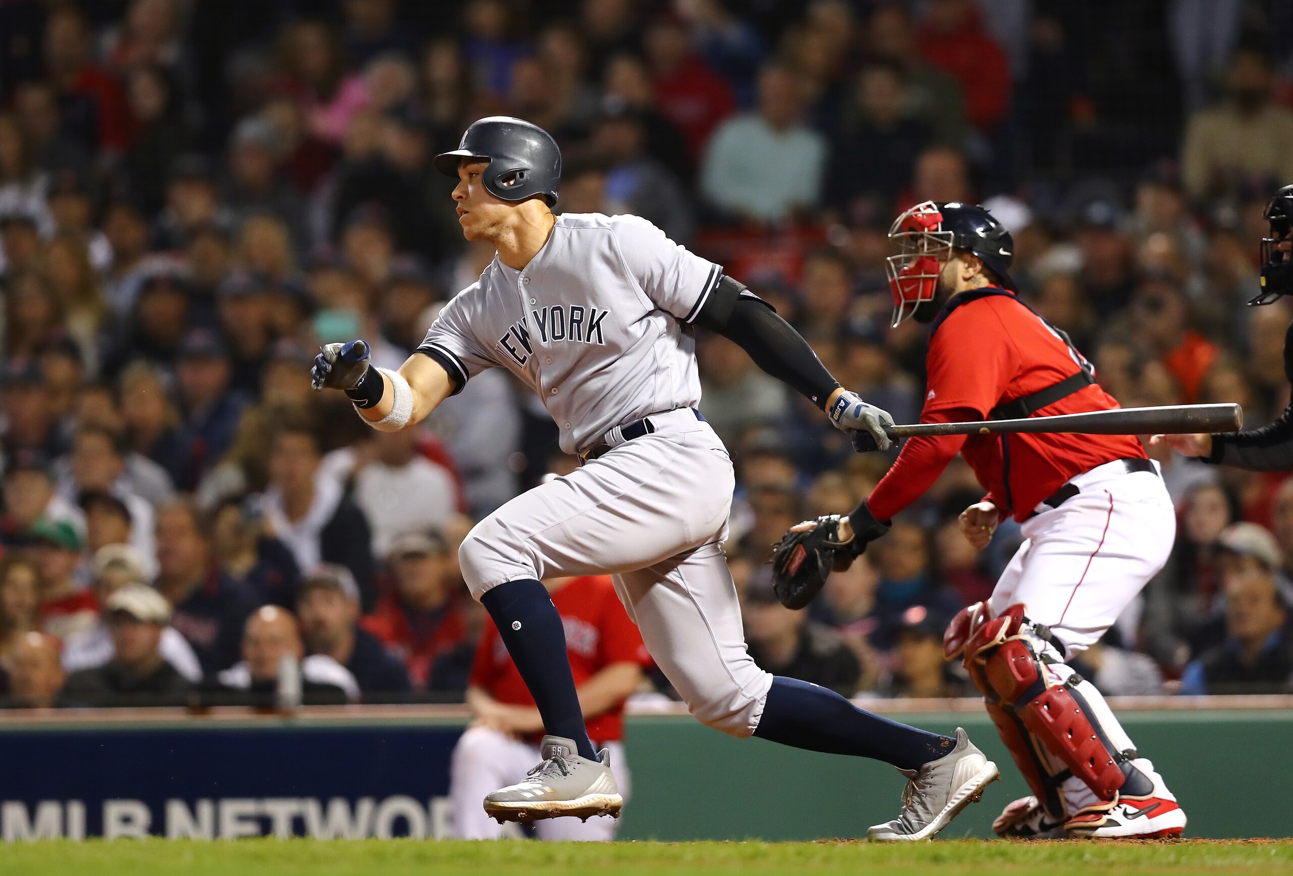 BOSTON, MA - OCTOBER 06:  Aaron Judge #99 of the New York Yankees hits an infield single to first base during the seventh inning of Game Two of the American League Division Series against the Boston Red Sox at Fenway Park on October 6, 2018 in Boston, Massachusetts.  (Photo by Tim Bradbury/Getty Images)