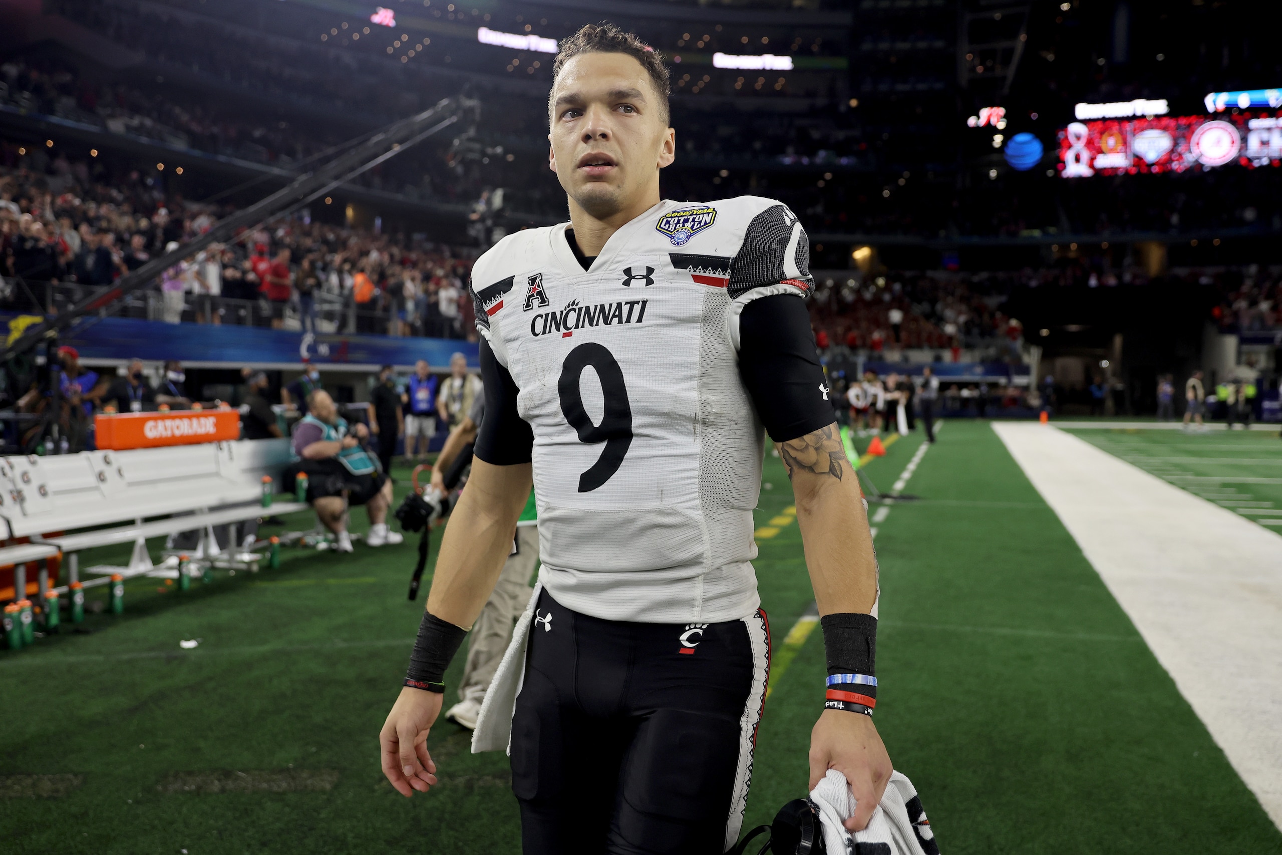 ARLINGTON, TEXAS - DECEMBER 31: Quarterback Desmond Ridder #9 of the Cincinnati Bearcats leaves the field after his team lost to the Alabama Crimson Tide during the Goodyear Cotton Bowl Classic for the College Football Playoff semifinal game at AT&T Stadium on December 31, 2021 in Arlington, Texas. (Photo by Matthew Stockman/Getty Images)