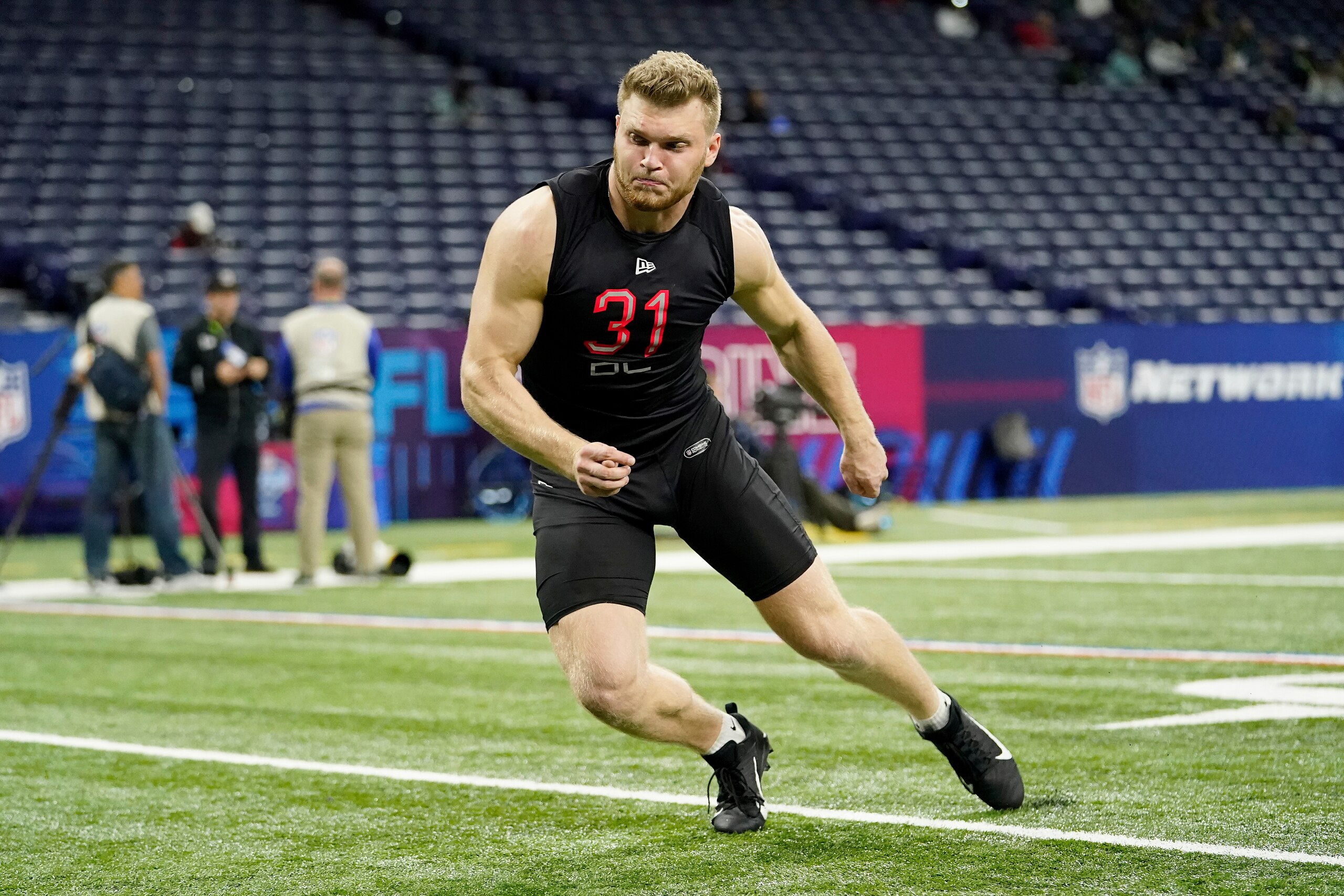 Michigan defensive lineman Aidan Hutchinson (31) participates in a drill at the NFL football scouting combine in Indianapolis, Saturday, March 5, 2022. (AP Photo/Steve Luciano)