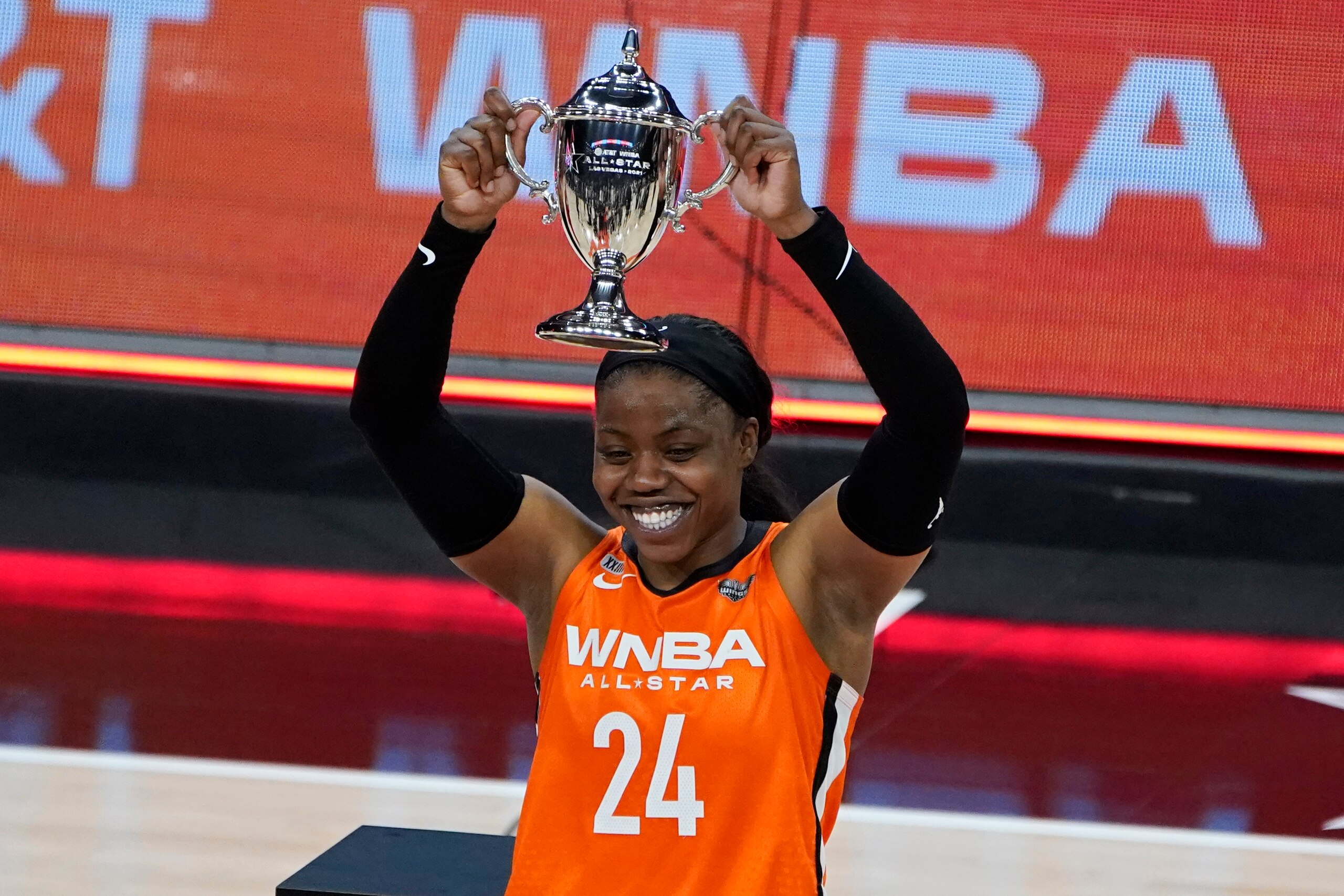 Team WNBA's Arike Ogunbowale holds up the MVP trophy after Team WNBA defeated United States in a WNBA All-Star basketball game, Wednesday, July 14, 2021, in Las Vegas. (AP Photo/John Locher)