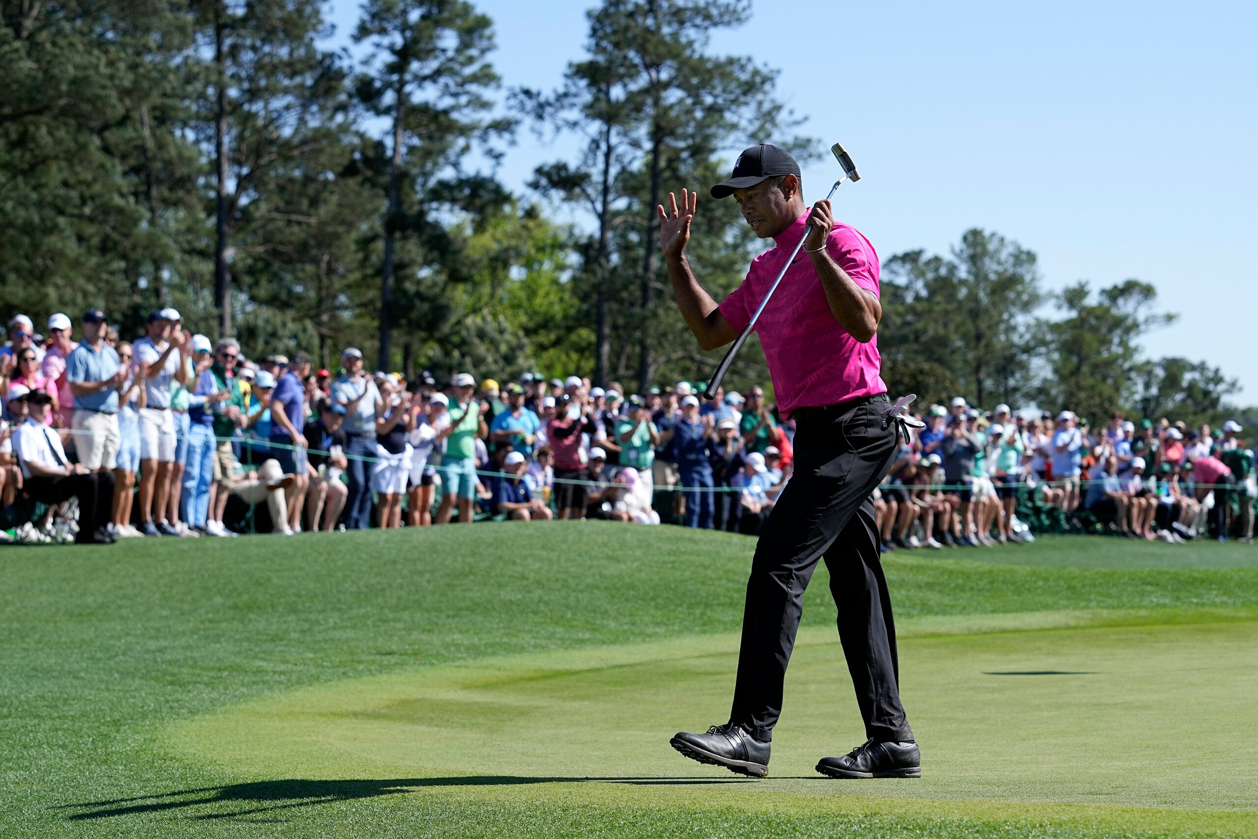 Tiger Woods acknowledges applause on the 18th green after finishing the first round at the Masters golf tournament on Thursday, April 7, 2022, in Augusta, Ga. (AP Photo/Robert F. Bukaty)