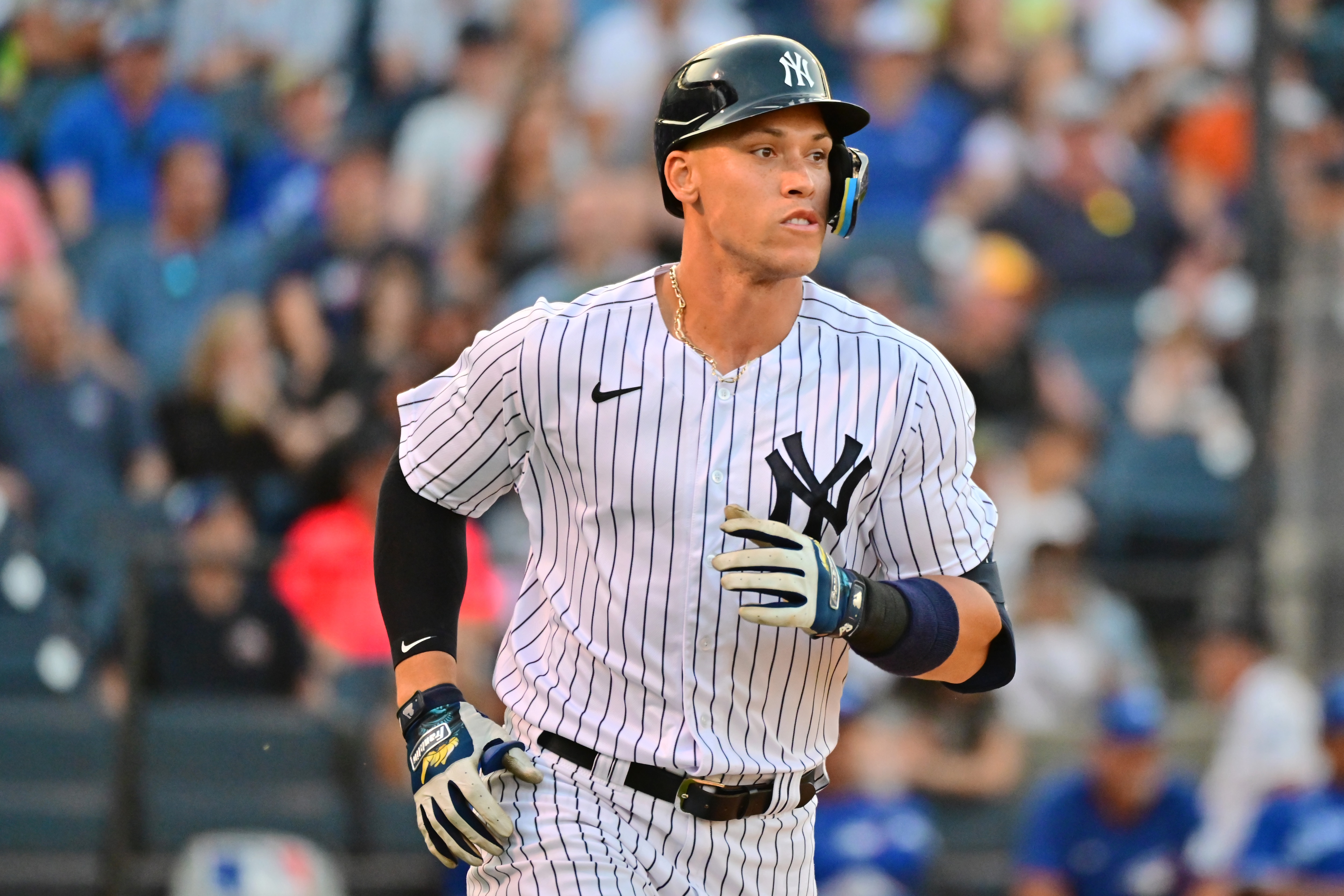 TAMPA, FLORIDA - MARCH 30: Aaron Judge #99 of the New York Yankees runs to first after hitting a single in the third inning against the Toronto Blue Jays during a Grapefruit League spring training game at George Steinbrenner Field on March 30, 2022 in Tampa, Florida. (Photo by Julio Aguilar/Getty Images)
