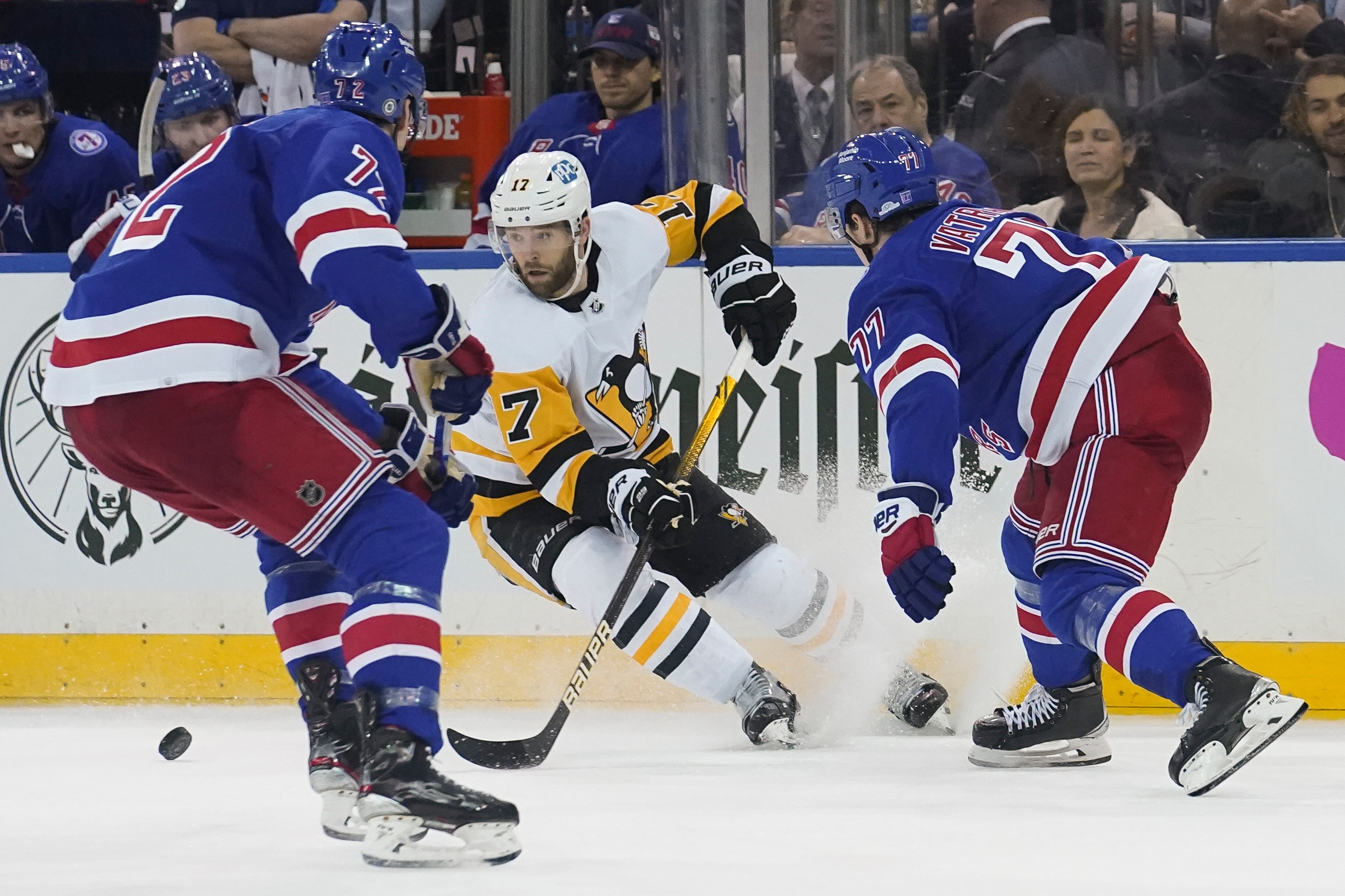 Pittsburgh Penguins right wing Bryan Rust (17) breaks against the New York Rangers defense during the third period of NHL hockey game Thursday, April 7, 2022, in New York. (AP Photo/Bebeto Matthews)