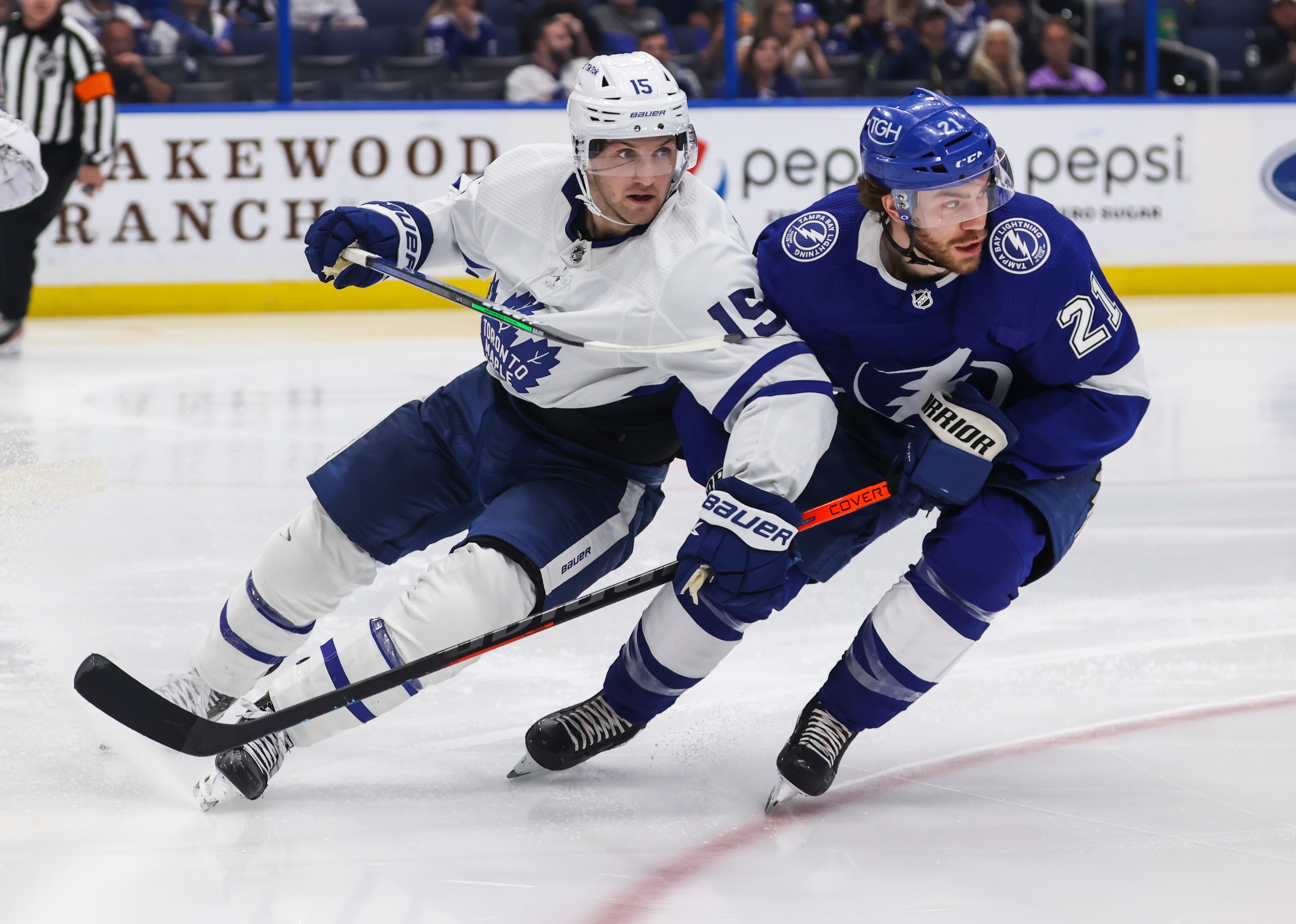 TAMPA, FL - APRIL 4: Brayden Point #21 of the Tampa Bay Lightning skates against Alexander Kerfoot #15 of the Toronto Maple Leafs during the second period at Amalie Arena on April 4, 2022 in Tampa, Florida. (Photo by Mark LoMoglio/NHLI via Getty Images)