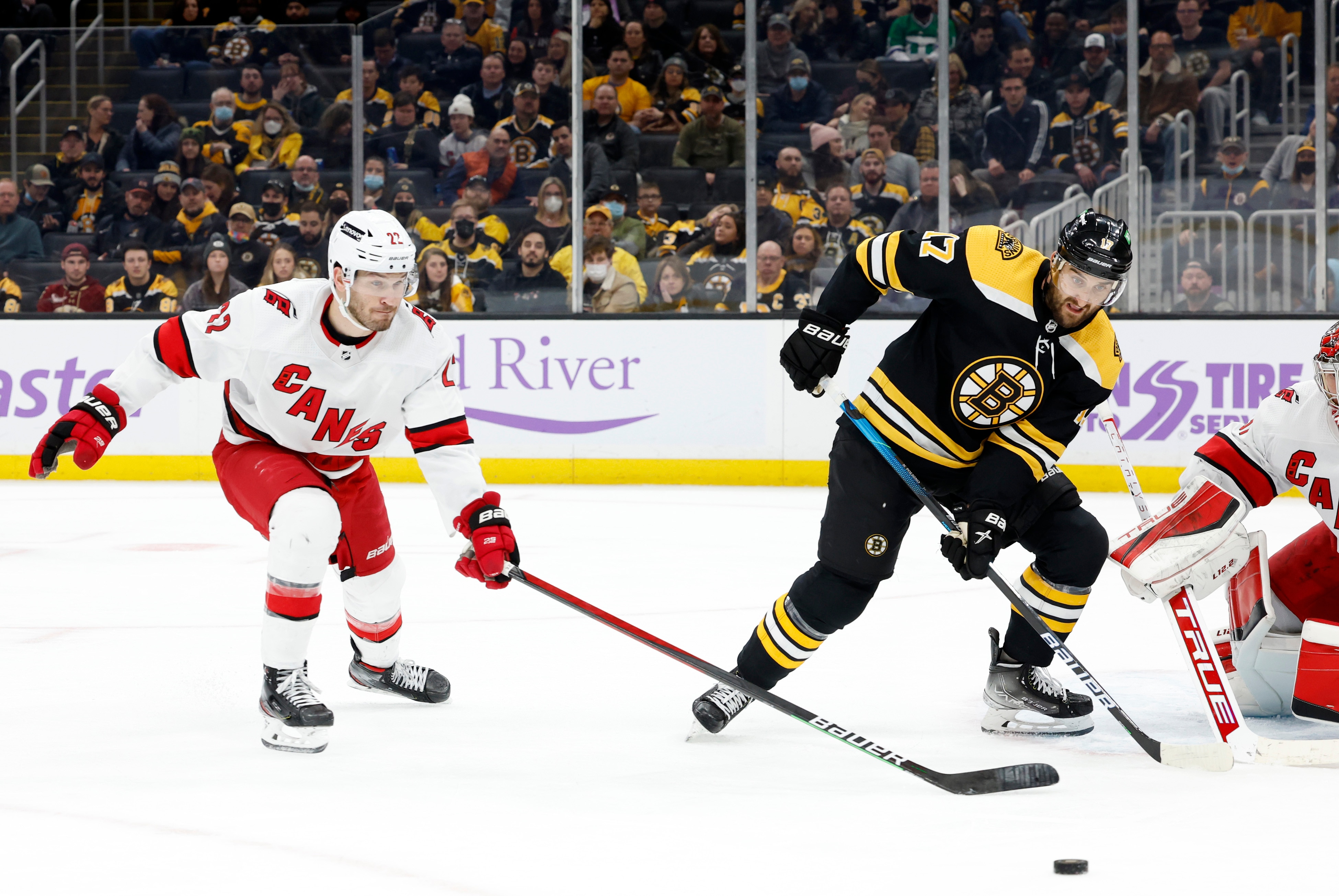 BOSTON, MA - FEBRUARY 10: Carolina Hurricanes defenseman Brett Pesce (22) moves in to break up a pass for Boston Bruins winger Nick Foligno (17) during a game between the Boston Bruins and the Carolina Hurricanes on February 10, 2022 at TD garden in Boston, Massachusetts. (Photo by Fred Kfoury III/Icon Sportswire via Getty Images)
