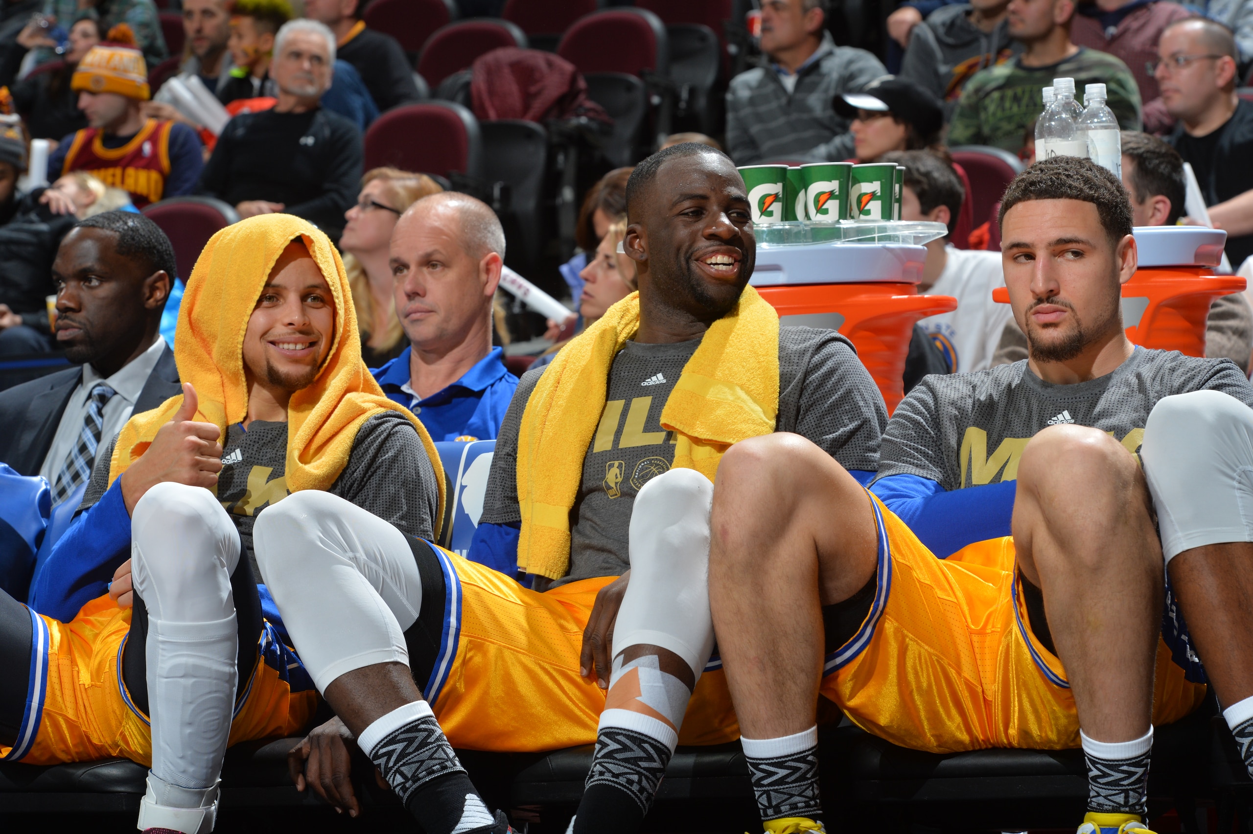 CLEVELAND, OH - JANUARY 18: Stephen Curry #30 of the Golden State Warriors smiles while resting on the bench along side Draymond Green #23 an Klay Thompson #11 against the Cleveland Cavaliers on January 18, 2016 at Quicken Loans Arena in Cleveland, Ohio. NOTE TO USER: User expressly acknowledges and agrees that, by downloading and/or using this Photograph, user is consenting to the terms and conditions of the Getty Images License Agreement. Mandatory Copyright Notice: Copyright 2016 NBAE (Photo by Jesse D. Garrabrant/NBAE via Getty Images)
