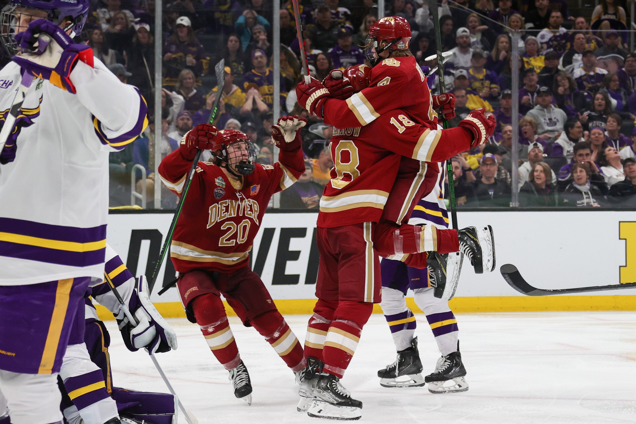 BOSTON, MA - APRIL 09: Ryan Barrow #18 of the Denver Pioneers is congratulated by teammates and Jack Devine #4 and Mike Benning #20 after a goal by Barrow in the third period of the Division I Mens Ice Hockey Championship against the Minnesota State Mavericks at the TD Garden on April 09, 2022 in Boston, Massachusetts. (Photo by Damian Strohmeyer/NCAA Photos via Getty Images) BOSTON, MA - APRIL 09: Ryan Barrow #18 of the Denver Pioneers is congratulated by teammates and Jack Devine #4 and Mike Benning #20 after a goal by Barrow in the third period of the Division I Mens Ice Hockey Championship against the Minnesota State Mavericks at the TD Garden on April 09, 2022 in Boston, Massachusetts. (Photo by Damian Strohmeyer/NCAA Photos via Getty Images)
