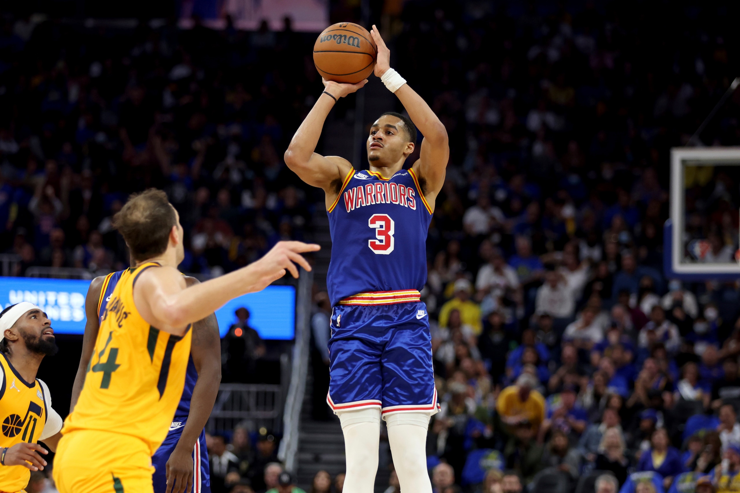 Golden State Warriors guard Jordan Poole (3) shoots against Utah Jazz forward Bojan Bogdanovic (44) during the first half of an NBA basketball game in San Francisco, Saturday, April 2, 2022. (AP Photo/Jed Jacobsohn)