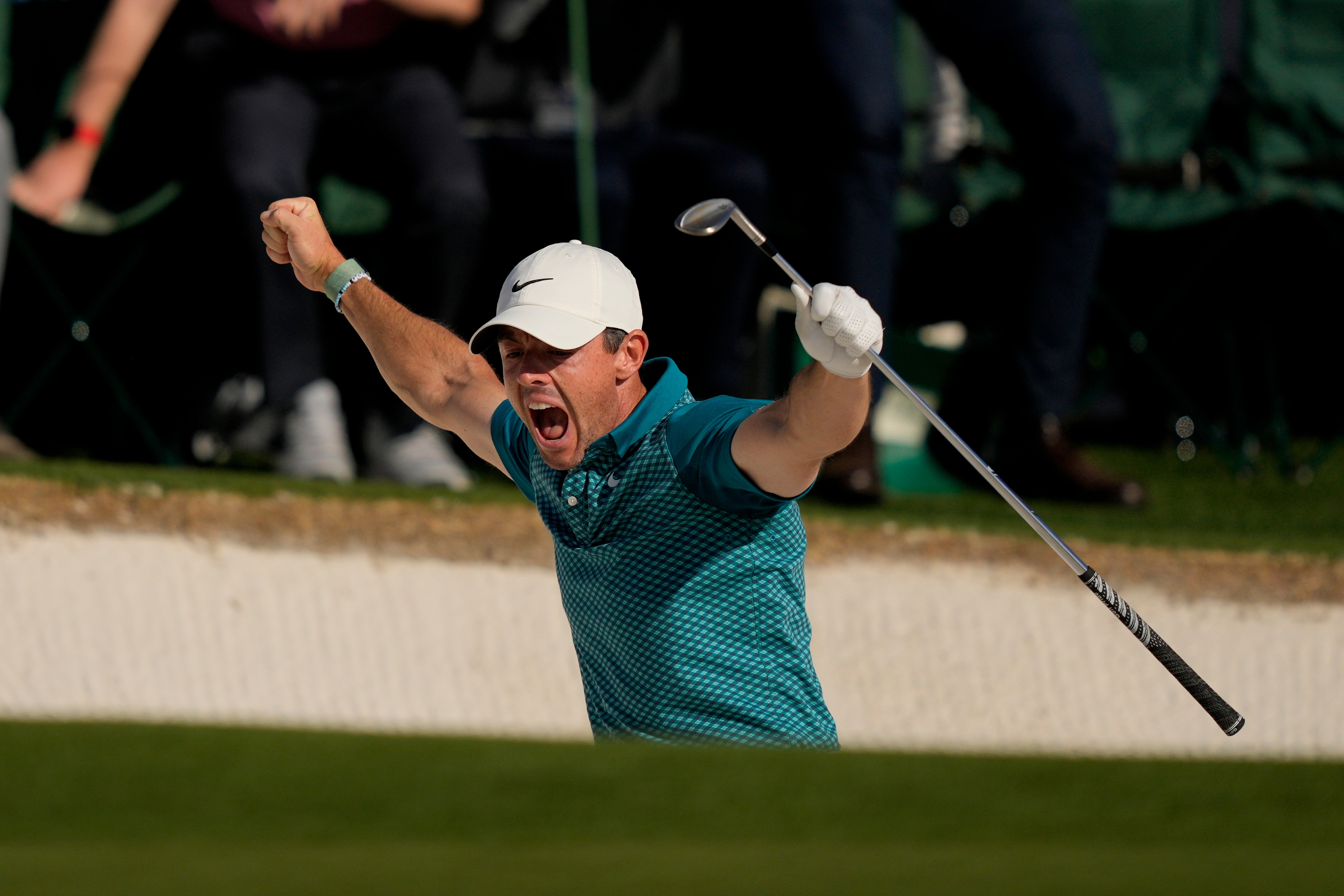 Rory McIlroy, of Northern Ireland, reacts after holing out from the bunker for a birdie during the final round at the Masters golf tournament on Sunday, April 10, 2022, in Augusta, Ga. (AP Photo/Matt Slocum)