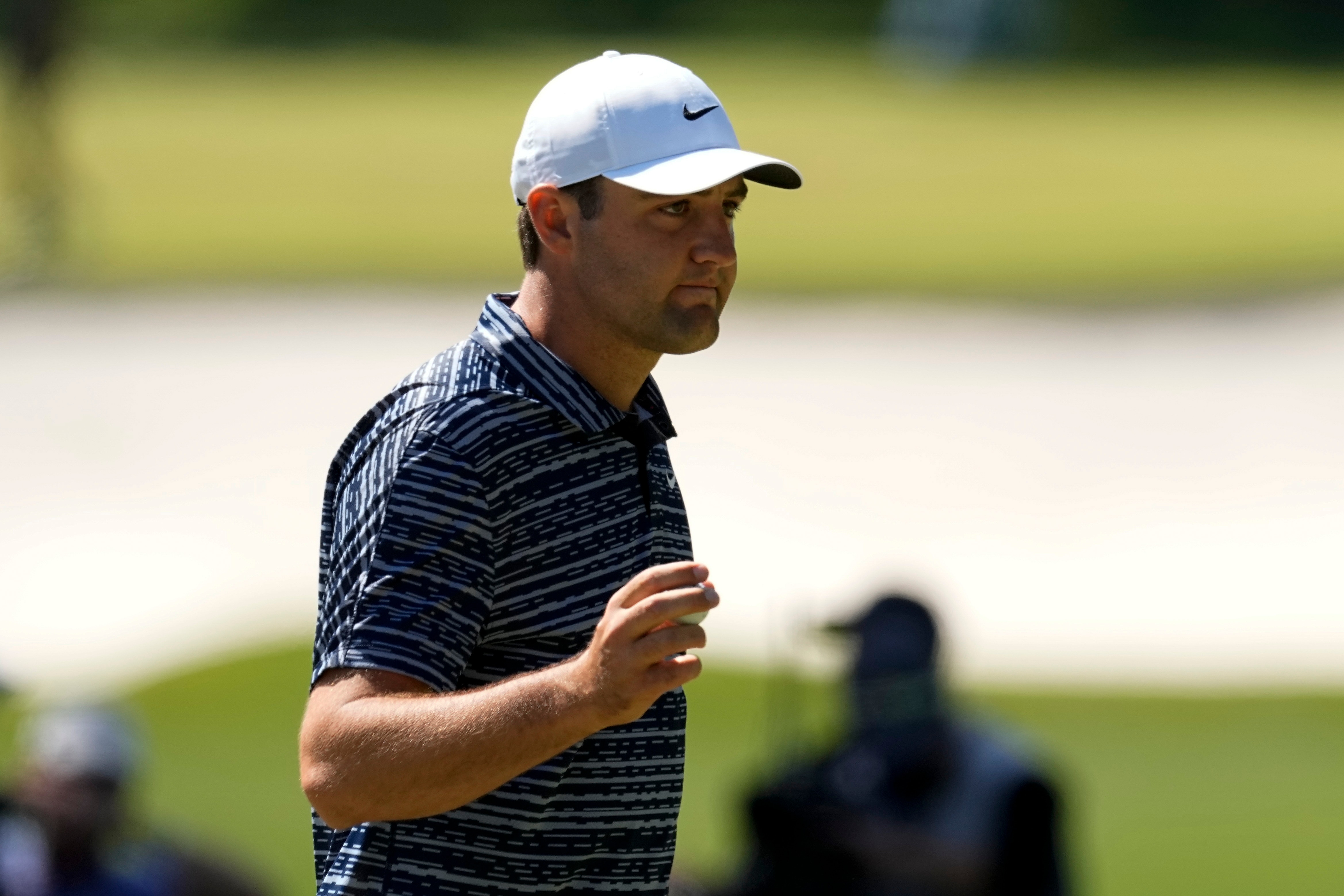 Scottie Scheffler holds up his ball after chipping in for birdie on the third hole during the final round at the Masters golf tournament on Sunday, April 10, 2022, in Augusta, Ga. (AP Photo/Robert F. Bukaty)