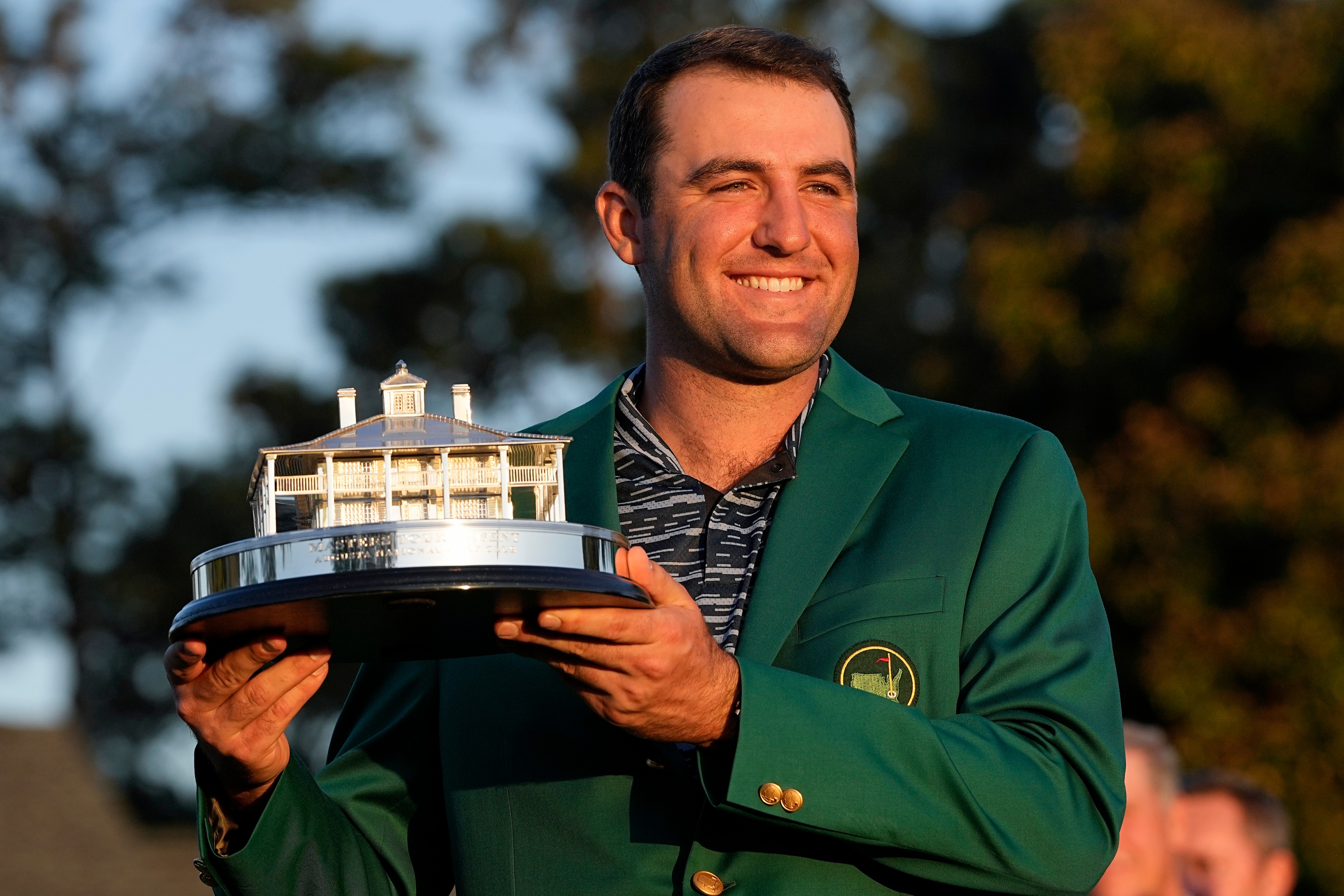 Scottie Scheffler holds the championship trophy after winning the 86th Masters golf tournament on Sunday, April 10, 2022, in Augusta, Ga. (AP Photo/David J. Phillip)