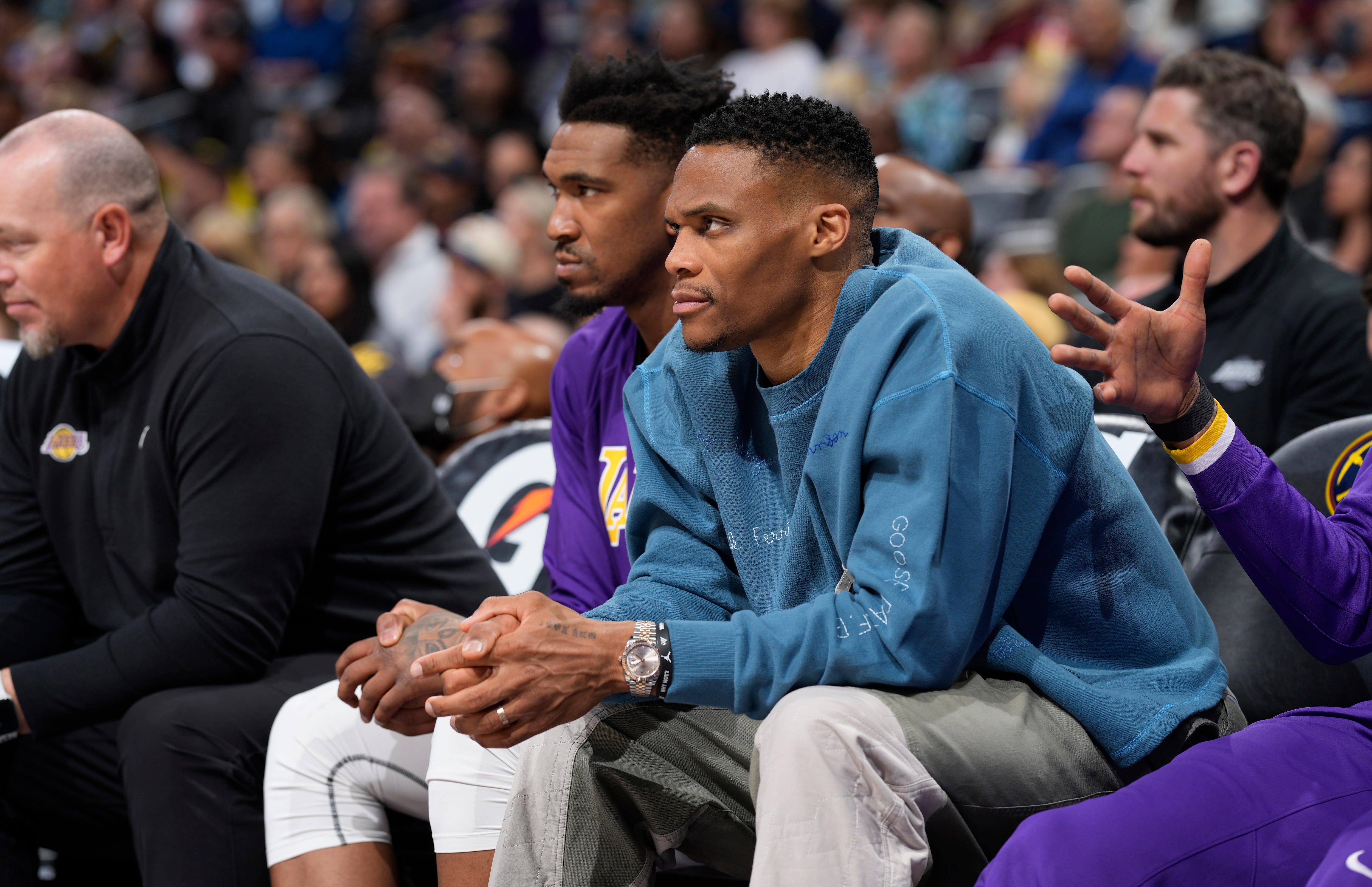 Los Angeles Lakers guards Russell Westbrook, front, and Malik Monk look on from the bench in the first half of an basketball game against the Denver Nuggets Sunday, April 10, 2022, in Denver. (AP Photo/David Zalubowski)