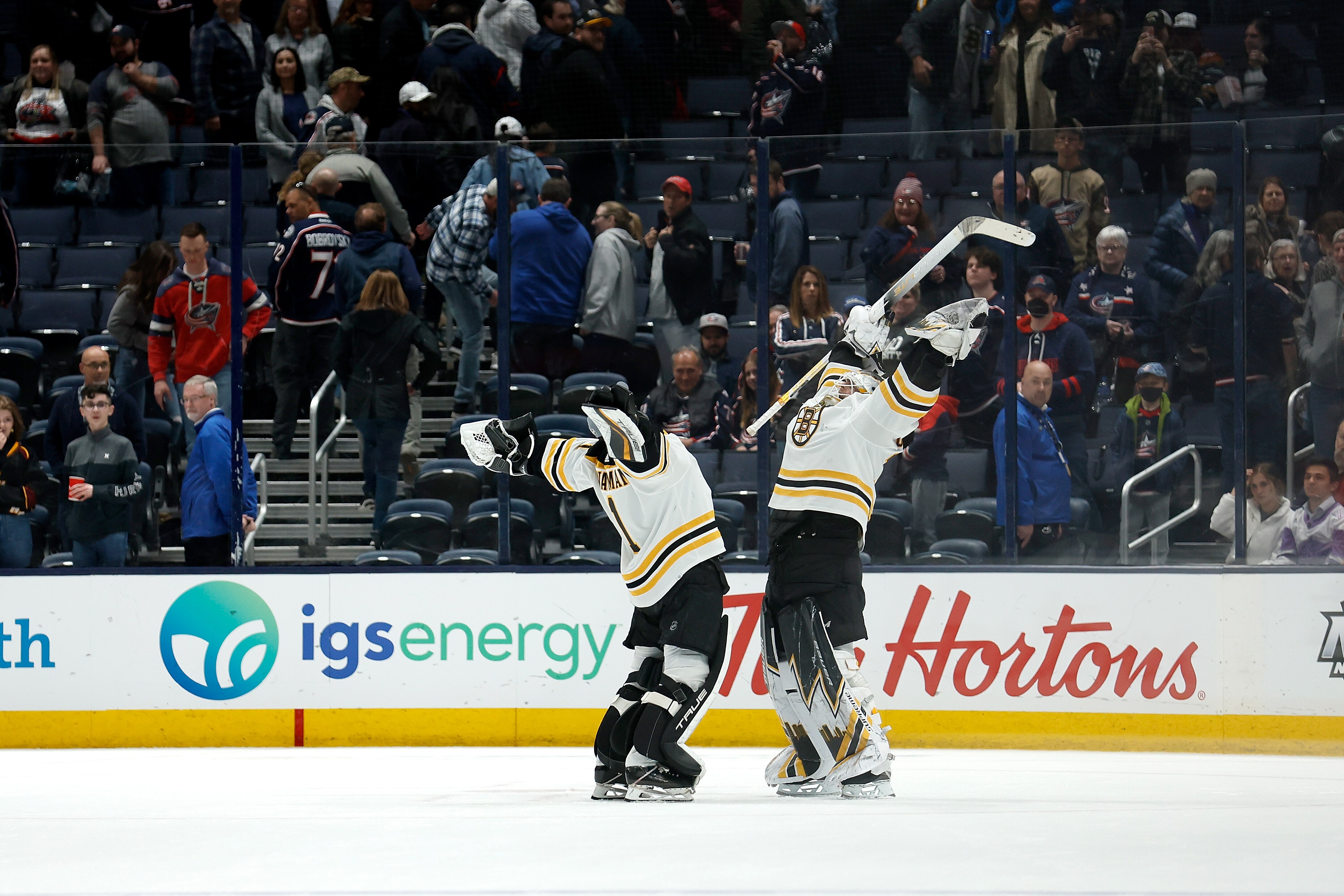 COLUMBUS, OH - APRIL 04: Linus Ullmark #35 of the Boston Bruins celebrates with Jeremy Swayman #1 after defeating the Columbus Blue Jackets 3-2 in overtime at Nationwide Arena on April 4, 2022 in Columbus, Ohio. (Photo by Kirk Irwin/Getty Images)