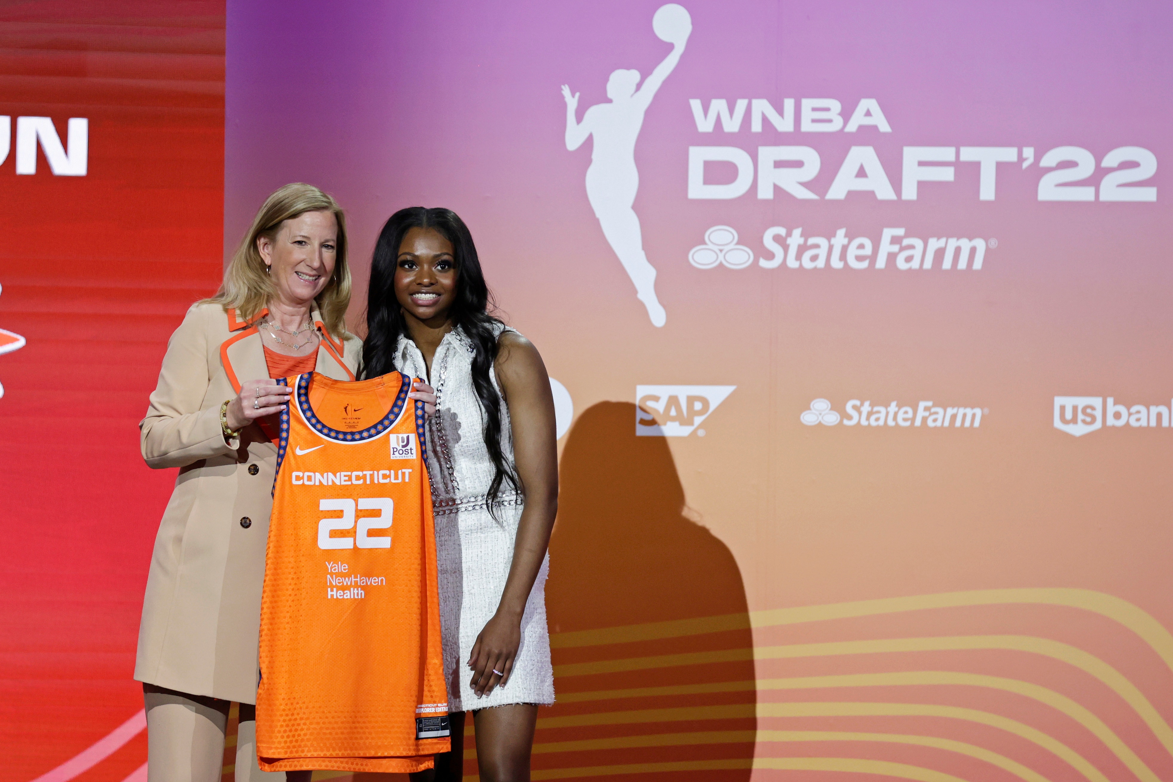 Michigan State's Nia Clouden, right, poses for a photo with commissioner Cathy Engelbert after being selected by the Connecticut Sun as the 12th overall pick in the WNBA basketball draft, Monday, April 11, 2022, in New York. (AP Photo/Adam Hunger)