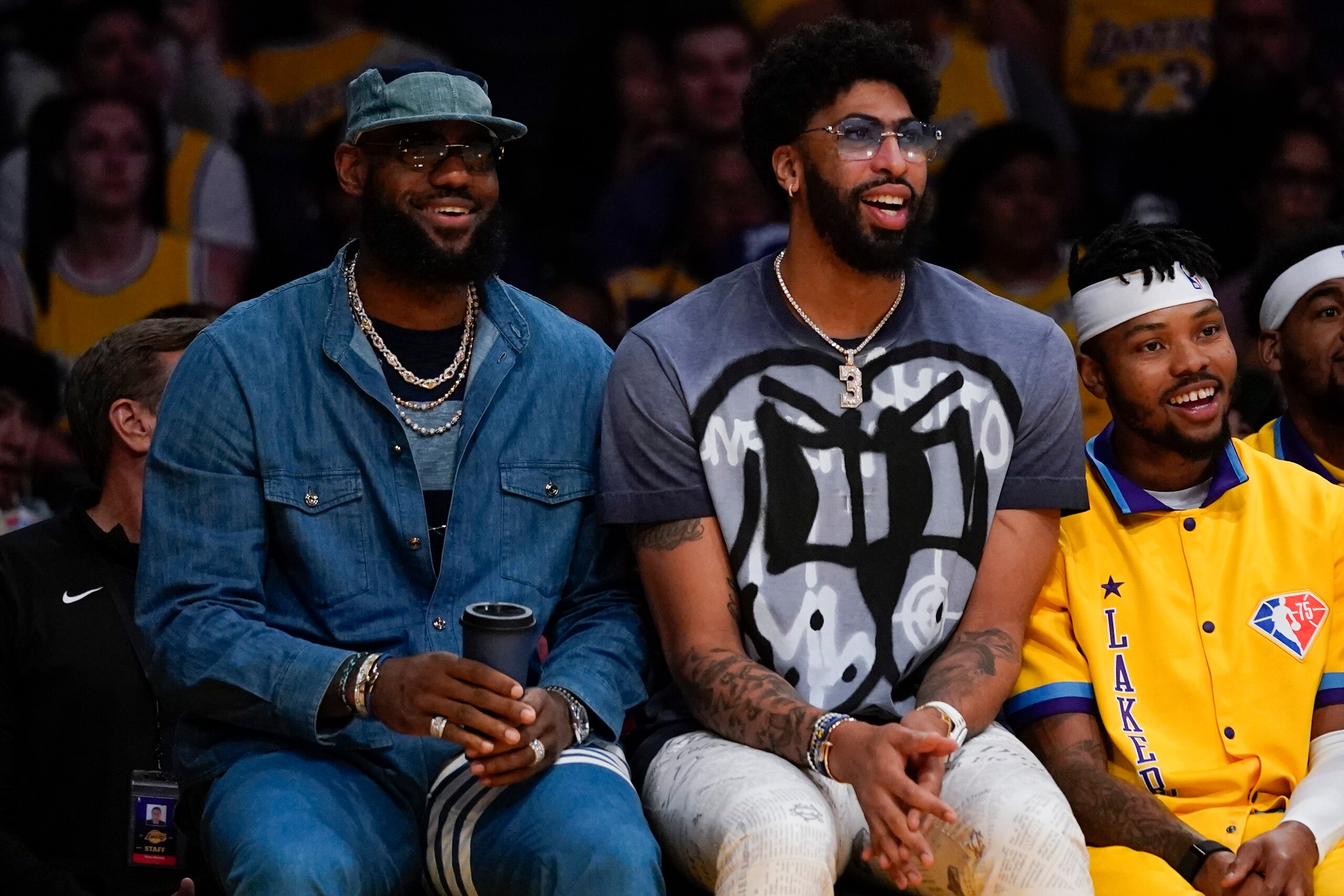 Los Angeles Lakers' LeBron James, Left, and Anthony Davis sit on the bench during the first half of an NBA basketball game against the Oklahoma City Thunder in Los Angeles, Friday, April 8, 2022. Neither played because of injury. (AP Photo/Ashley Landis)