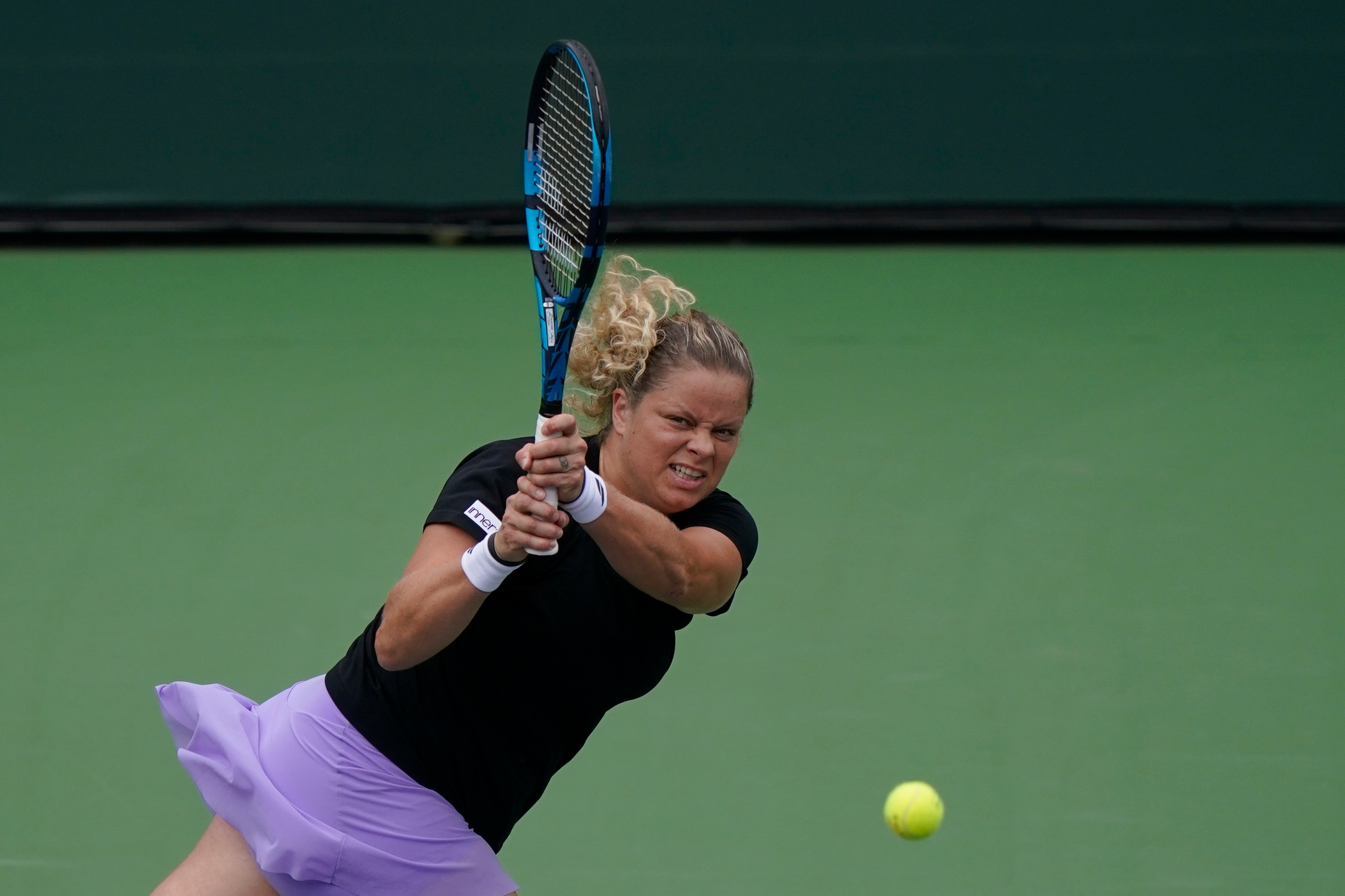 Kim Clijsters, of Belgium, returns a shot to Katerina Siniakova, of the Czech Republic, at the BNP Paribas Open tennis tournament Thursday, Oct. 7, 2021, in Indian Wells, Calif. (AP Photo/Mark J. Terrill)