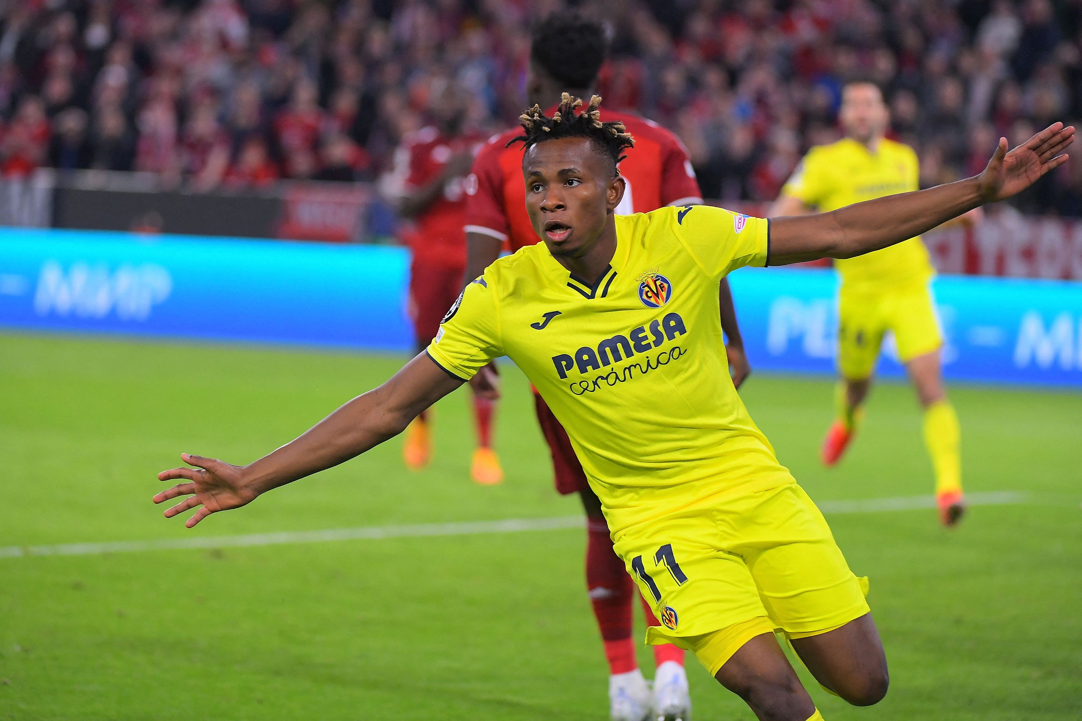 Villarreal's Nigerian midfielder Samuel Chukwueze celebrates scoring the 1-1 during the UEFA Champions League quarter-final, second leg football match FC Bayern Munich v FC Villarreal in Munich, southern Germany on April 12, 2022. (Photo by Jose Jordan / AFP) (Photo by JOSE JORDAN/AFP via Getty Images)