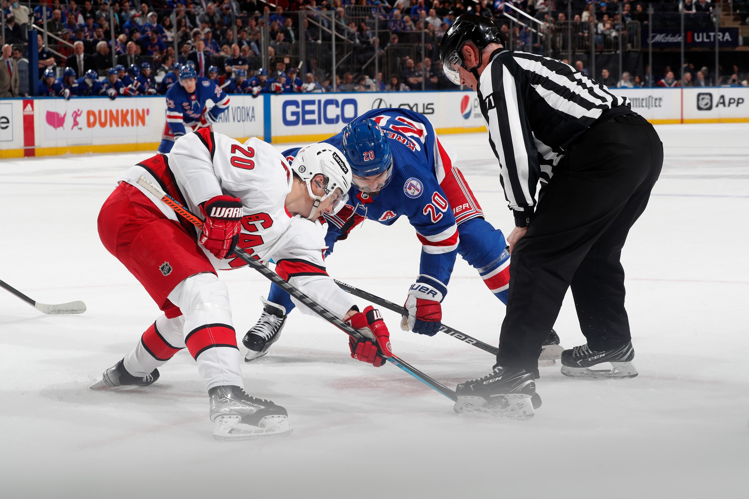 NEW YORK, NY - APRIL 12:  Chris Kreider #20 of the New York Rangers takes a face-off against Sebastian Aho #20 of the Carolina Hurricanes at Madison Square Garden on April 12, 2022 in New York City. (Photo by Jared Silber/NHLI via Getty Images)